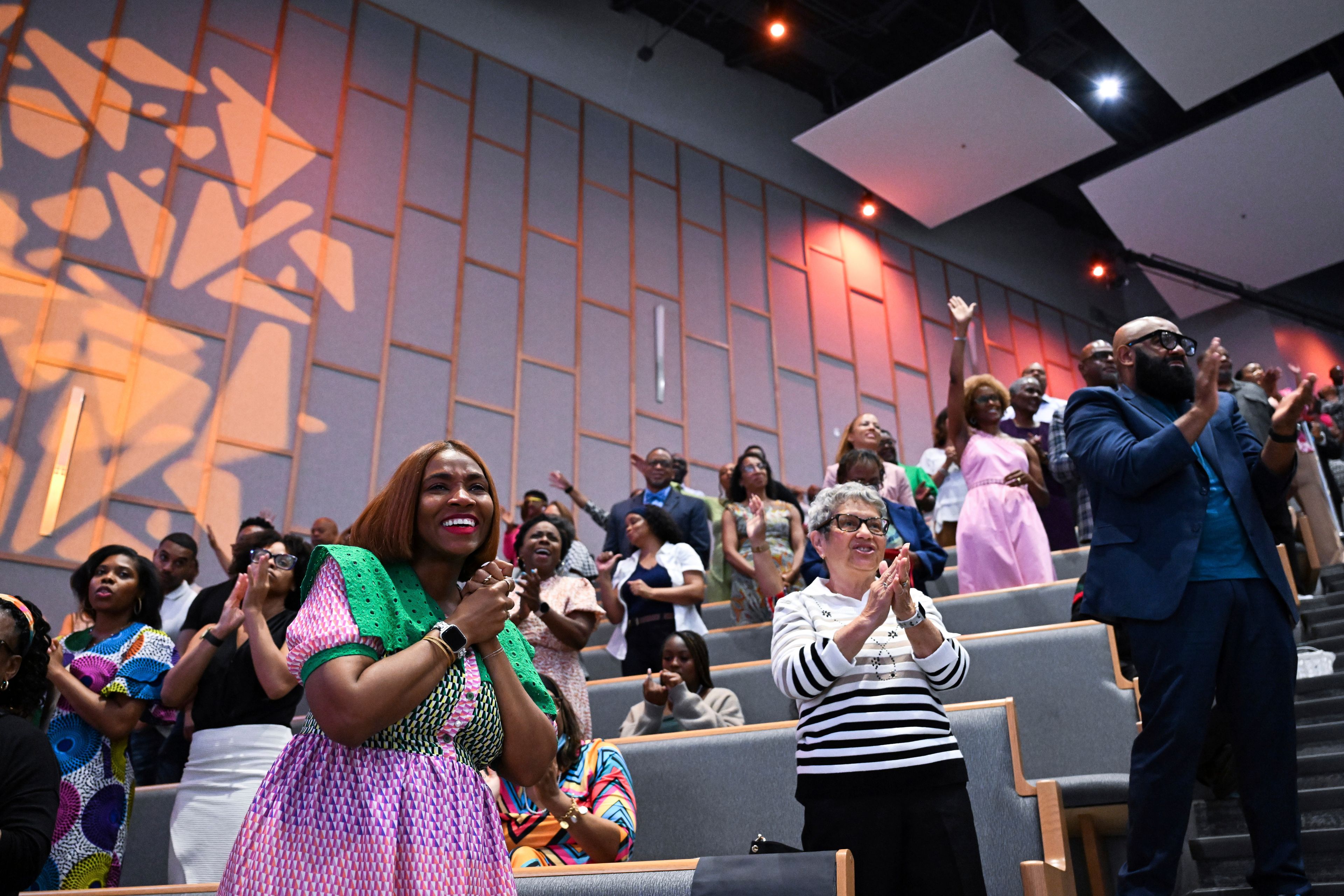 Members of the congregation stand and clap during church service at Kingdom Fellowship AME Church, Sunday, June 2, 2024, in Calverton, Md. The suburban Maryland congregation, led by the Rev. Matthew L. Watley, has landed at the top of a list of the fastest-growing churches in America.