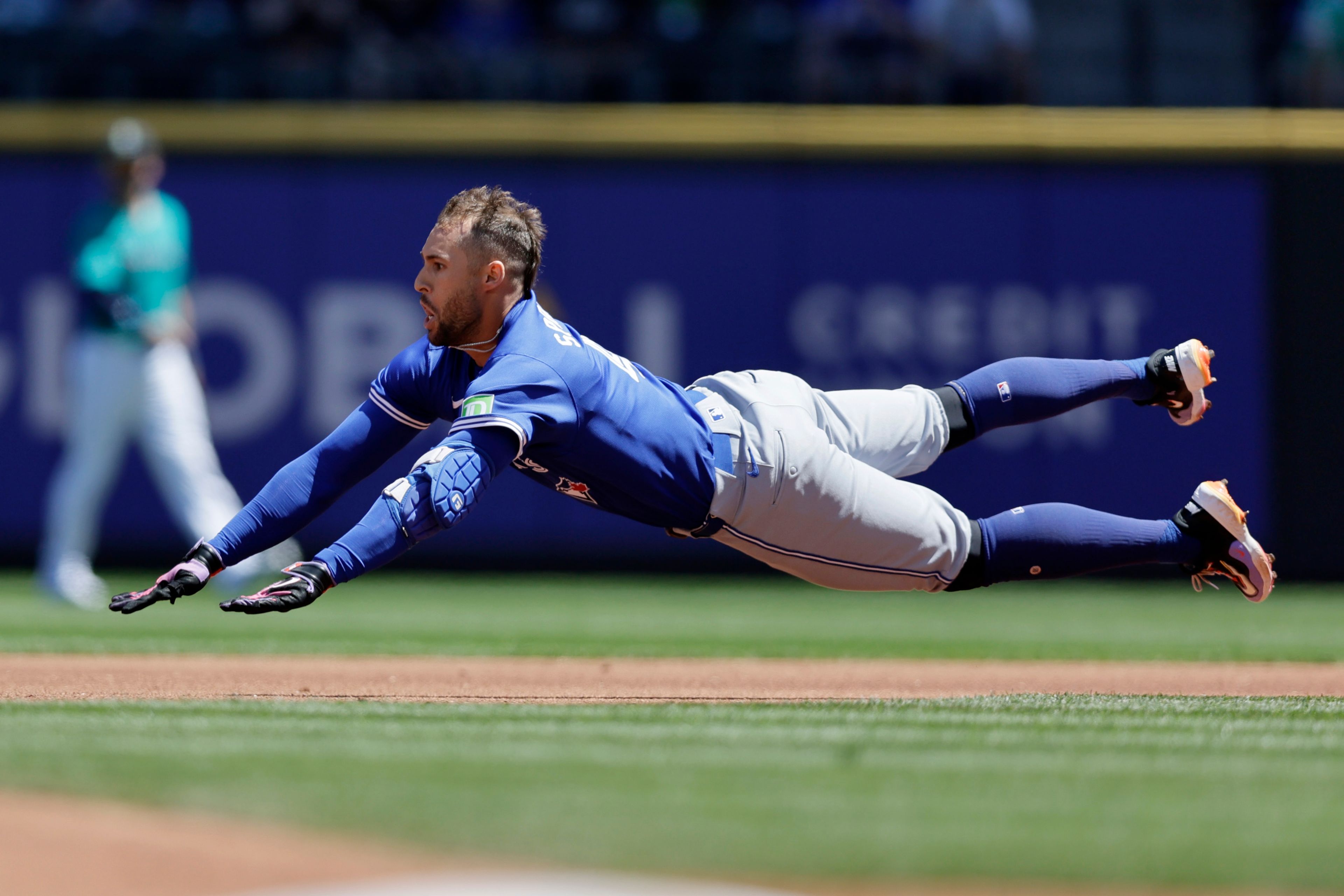 Toronto Blue Jays' George Springer dives into second for a double against the Seattle Mariners during the first inning in a baseball game, Saturday, July 6, 2024, in Seattle. (AP Photo/John Froschauer)