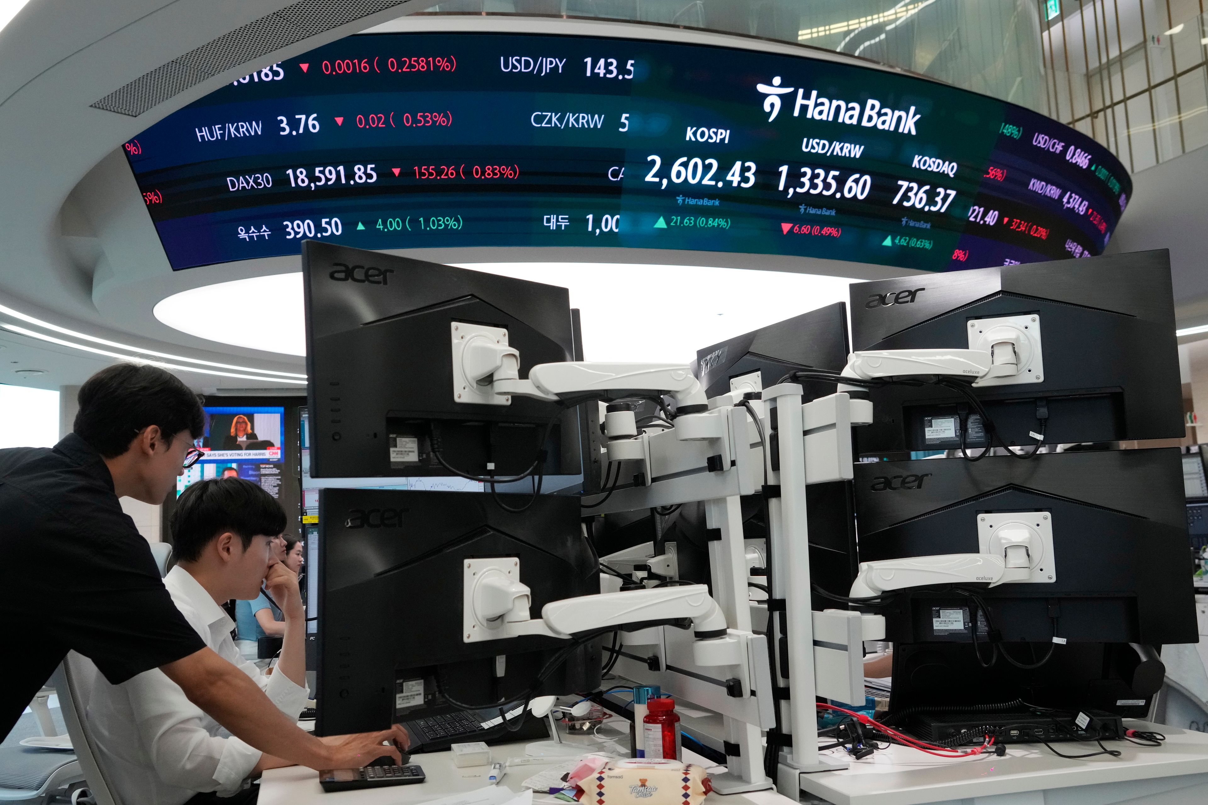 Currency traders watch monitors at the foreign exchange dealing room of the KEB Hana Bank headquarters in Seoul, South Korea, Thursday, Sept. 5, 2024.