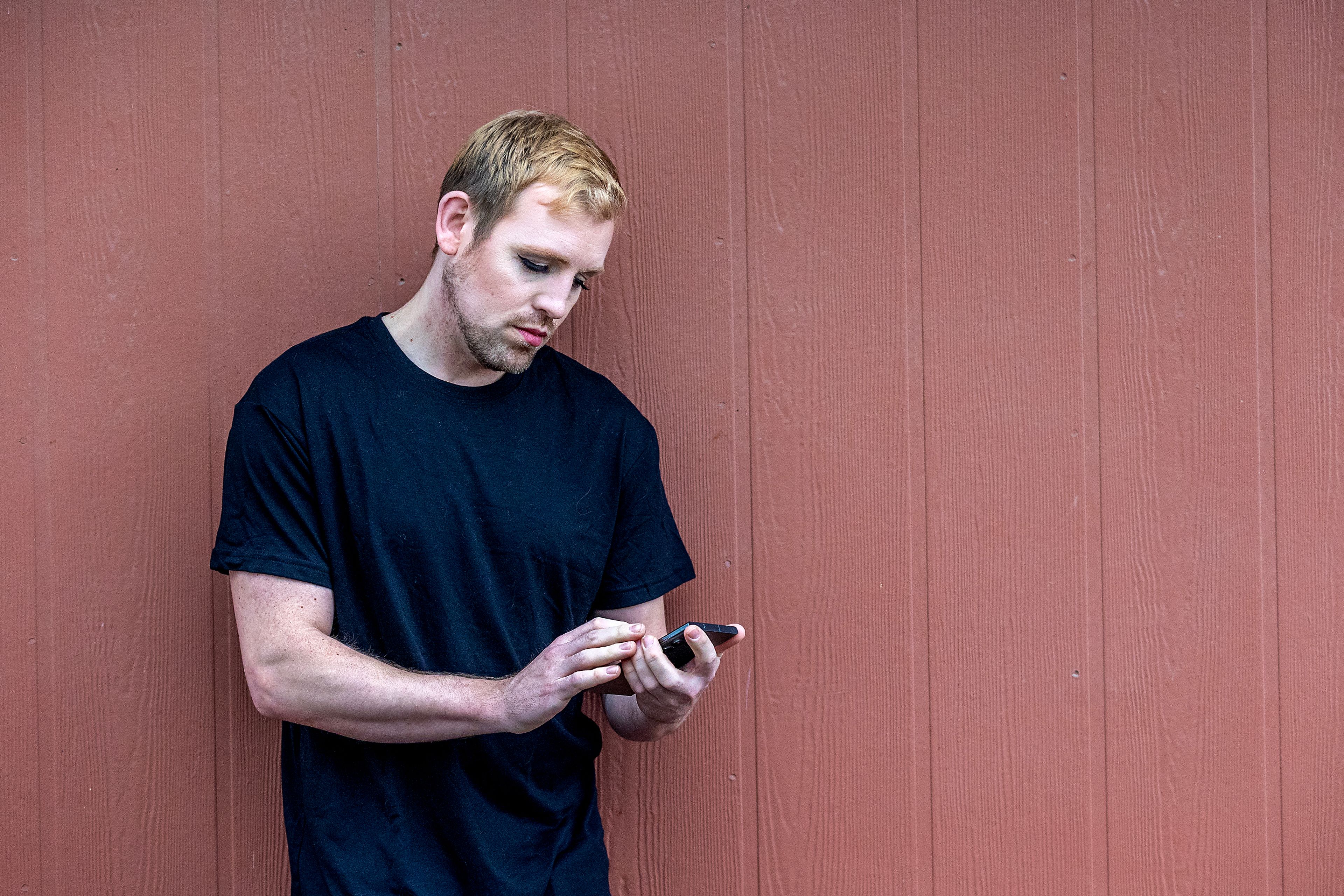 Micheal Keene poses for a photo wearing 2010s-inspired makeup applied by Jacey Johnson.