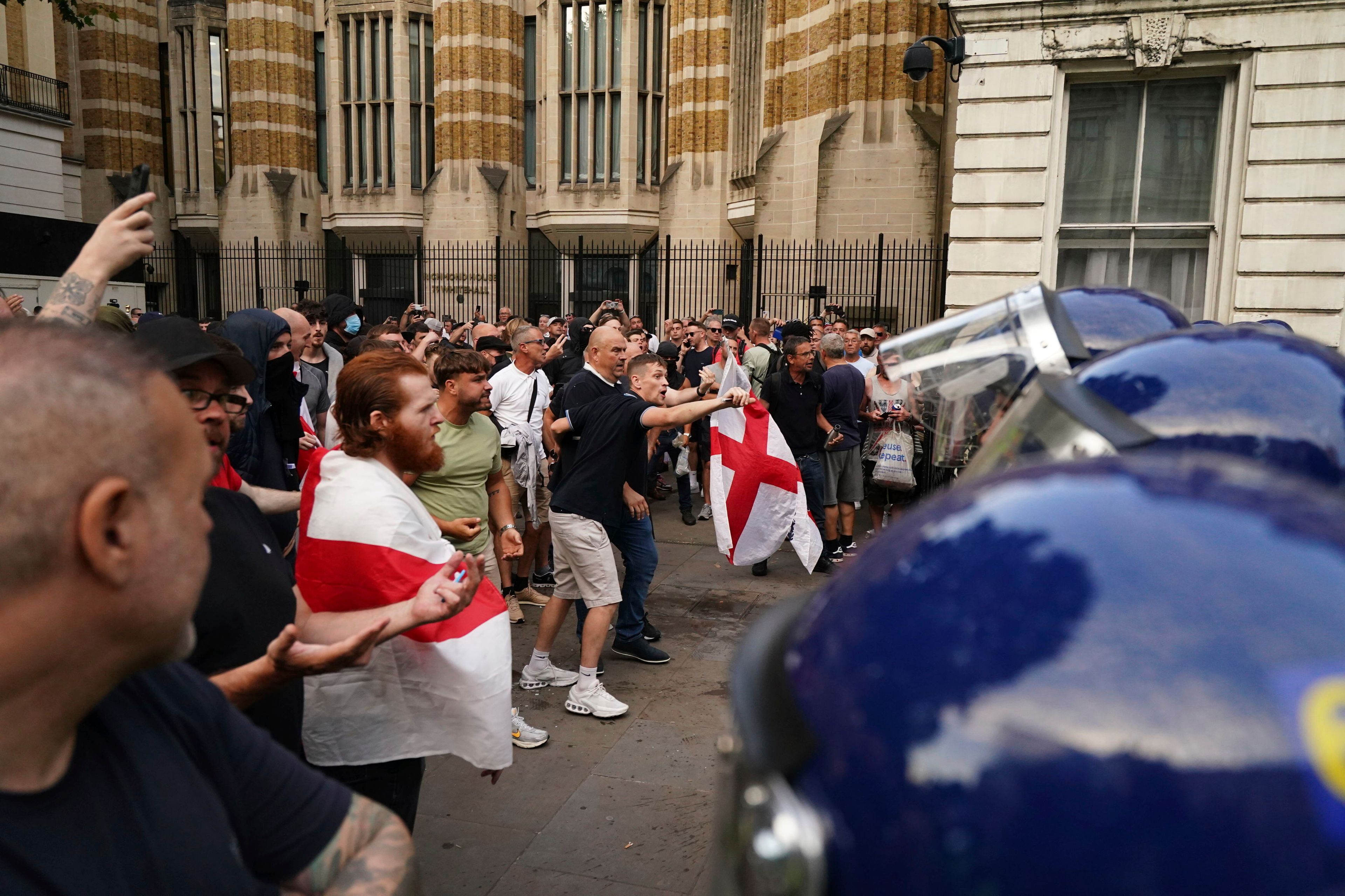 Protesters scuffle with police during the "Enough is Enough" protest in Whitehall, London, Wednesday July 31, 2024, following the fatal stabbing of three children at a Taylor Swift-themed summer holiday dance and yoga class on Monday in Southport. (Jordan Pettitt/PA via AP)