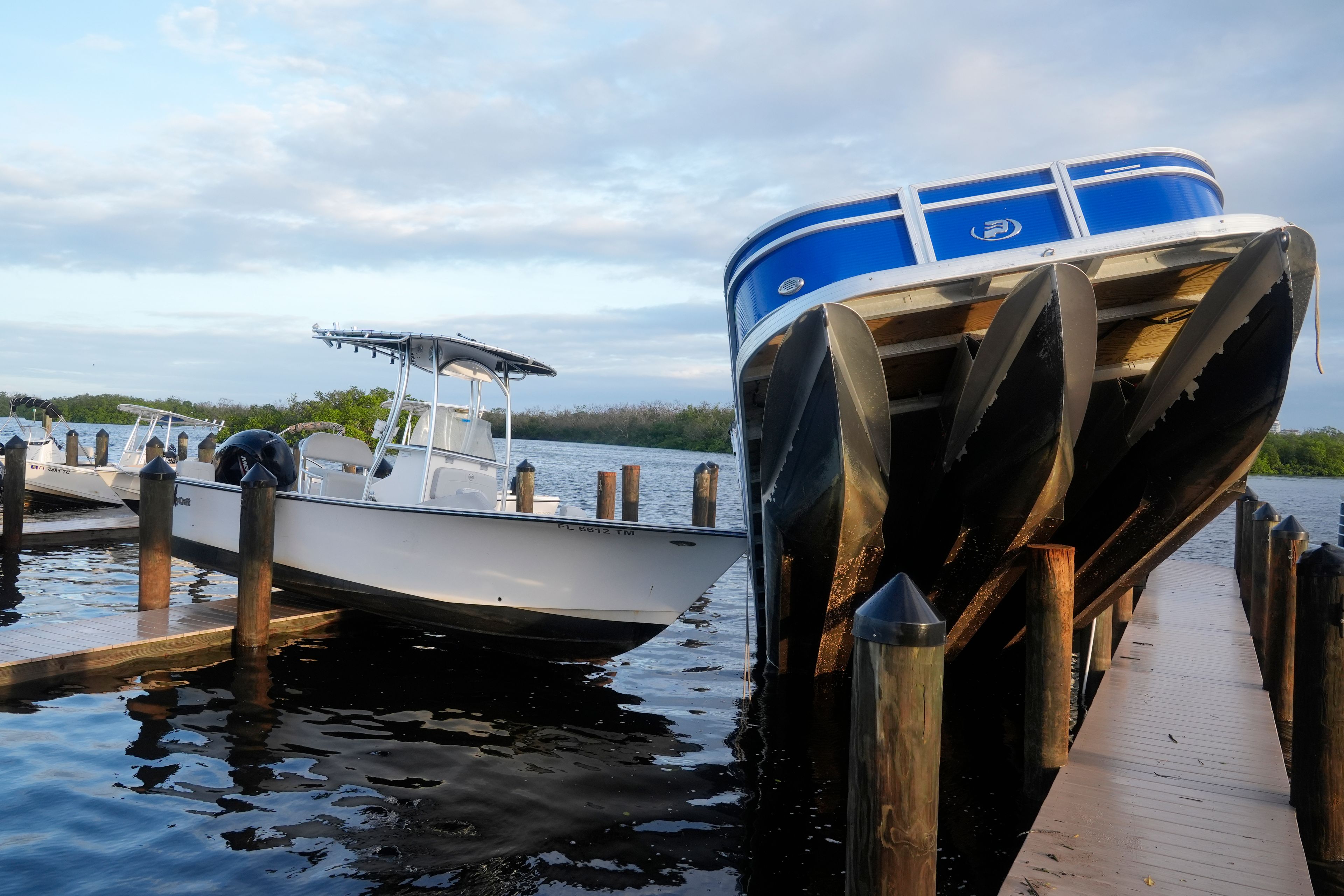 Small boats rests on a pier after they were unmoored during Hurricane Milton, Thursday, Oct. 10, 2024, in Fort Myers, Fla. (AP Photo/Marta Lavandier)