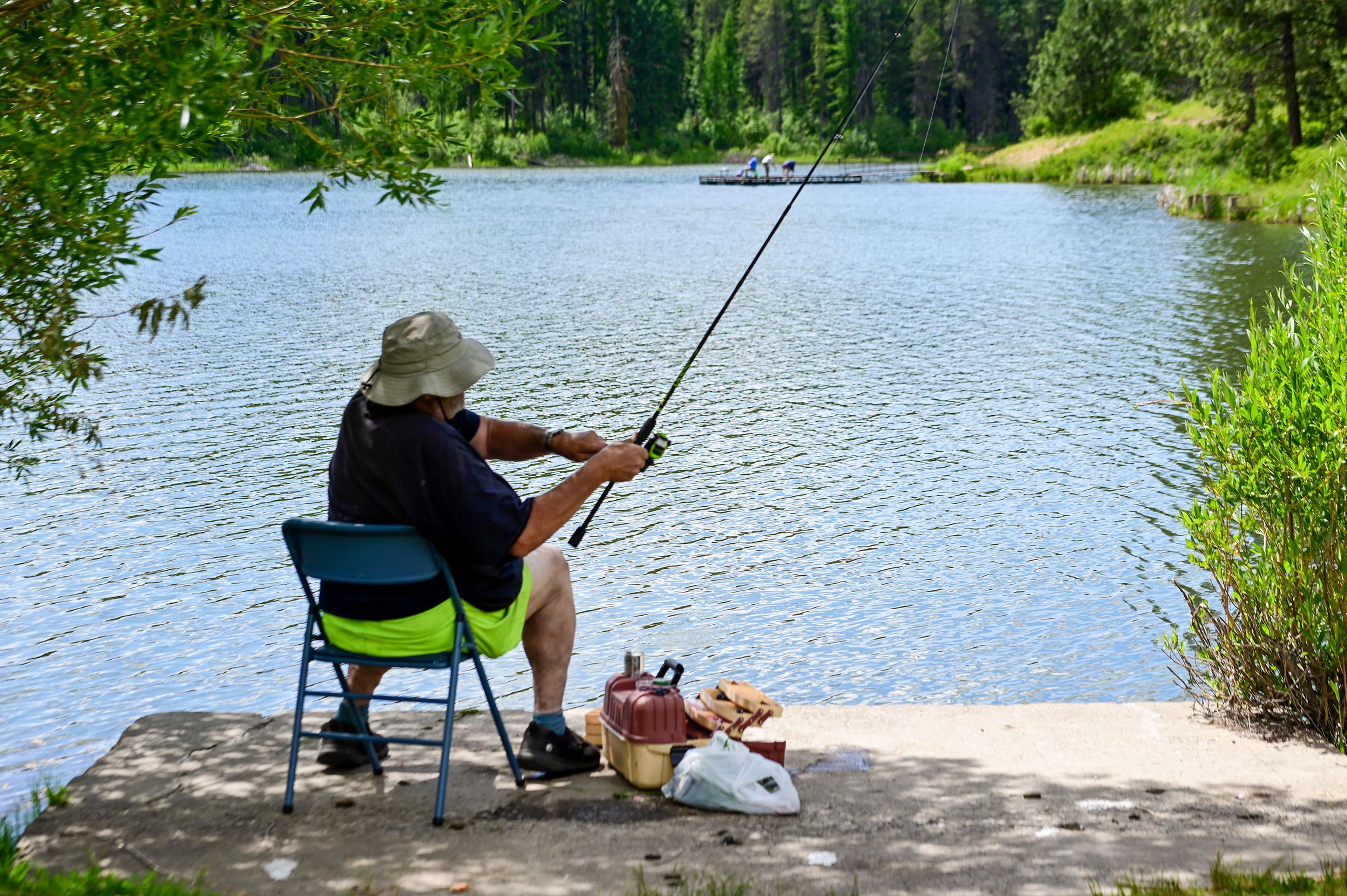 Randall Driskell, of Moscow, reels in his fishing line from his spot along the edge of the Spring Valley Reservoir outside of Troy on Friday.