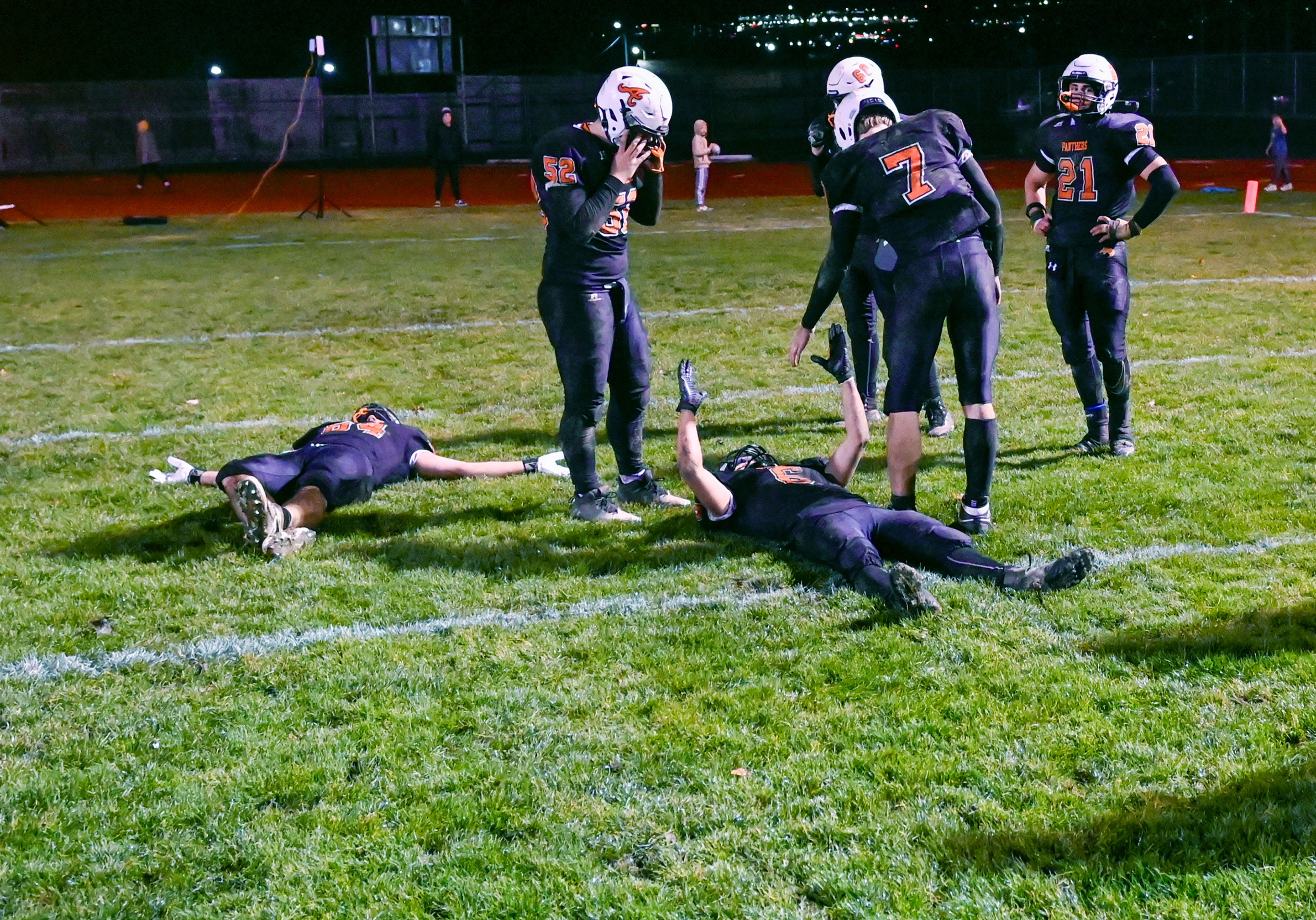 Asotin players lay on the field after their Washington 2B state tournament win over La Salle Saturday in Clarkston.