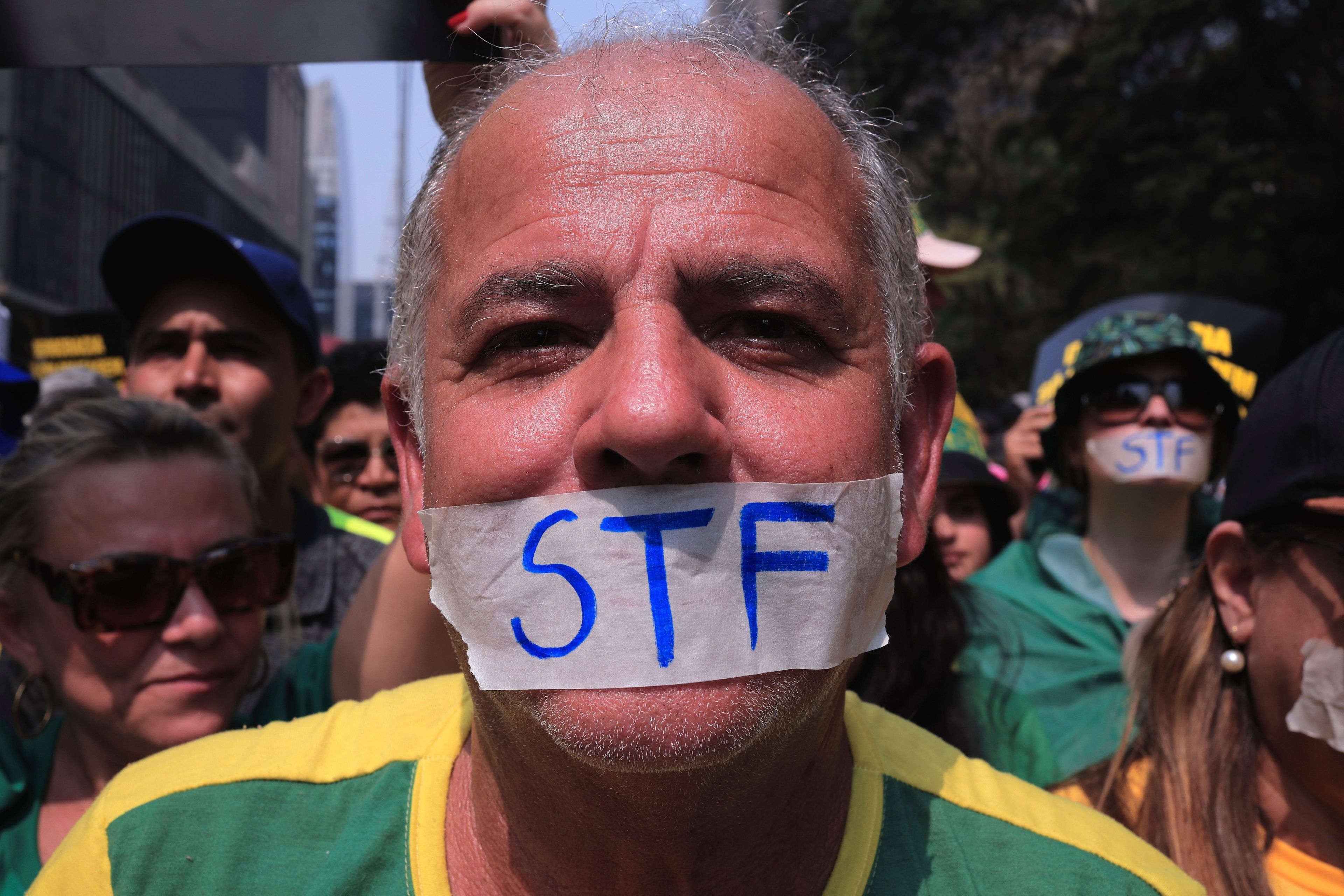 A demonstrator, his mouth covered with tape marked with the Brazilian Supreme Court acronym, takes part in a protest calling for the impeachment of Supreme Court Minister Alexandre de Moraes, who recently imposed a nationwide block on Elon Musk’s social media platform X, in Sao Paulo, Saturday, Sept. 7, 2024.