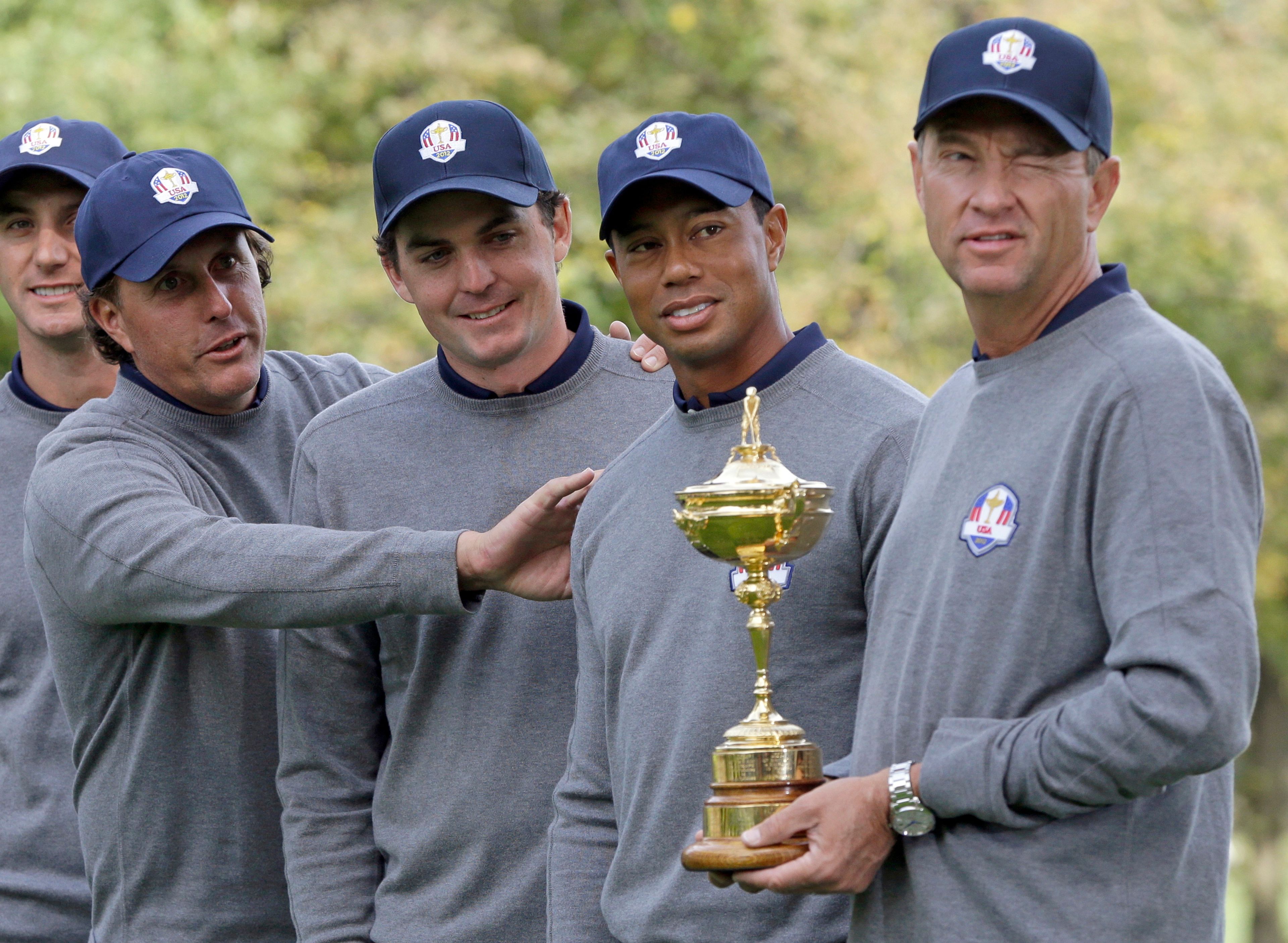 FILE - In this Sept. 25, 2012, file photo, from left, USA's Phil Mickelson, Keegan Bradley, Tiger Woods and captain Davis Love III have some fun as they pose for a picture with the trophy at the Ryder Cup golf tournament at Medinah Country Club in Medinah, Ill. Bradley was selected as U.S. Ryder Cup captain for 2025, The PGA of America announced Monday, July 8, 2024. (AP Photo/Chris Carlson, File)