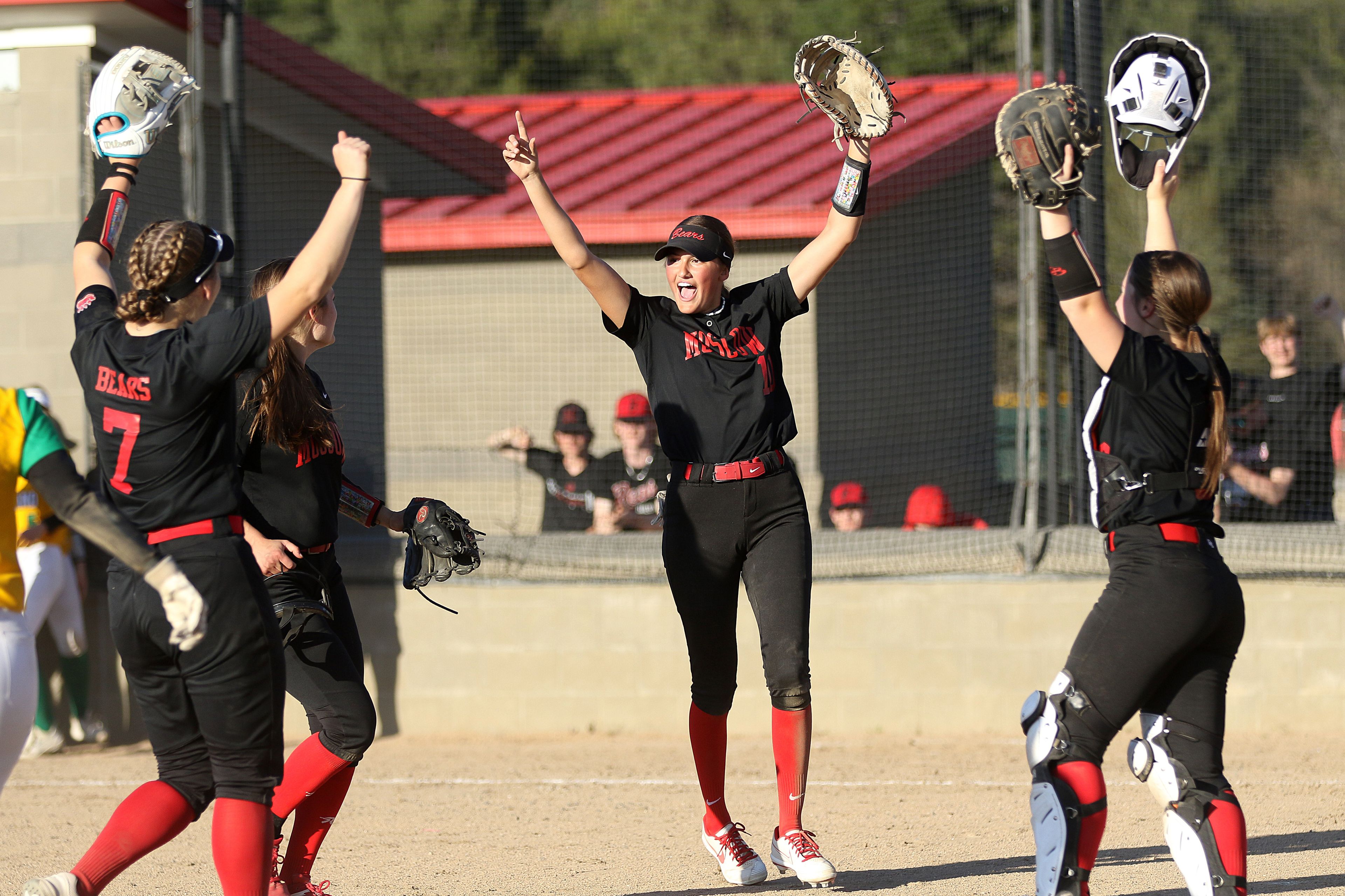 Moscow's Hannah Robertson (front left), Kelly Stodick (back left), Kaci Kiblen (middle) and Megan Highfill celebrate and Idaho Class 4A district championship win against Lakeland on Thursday in Moscow.