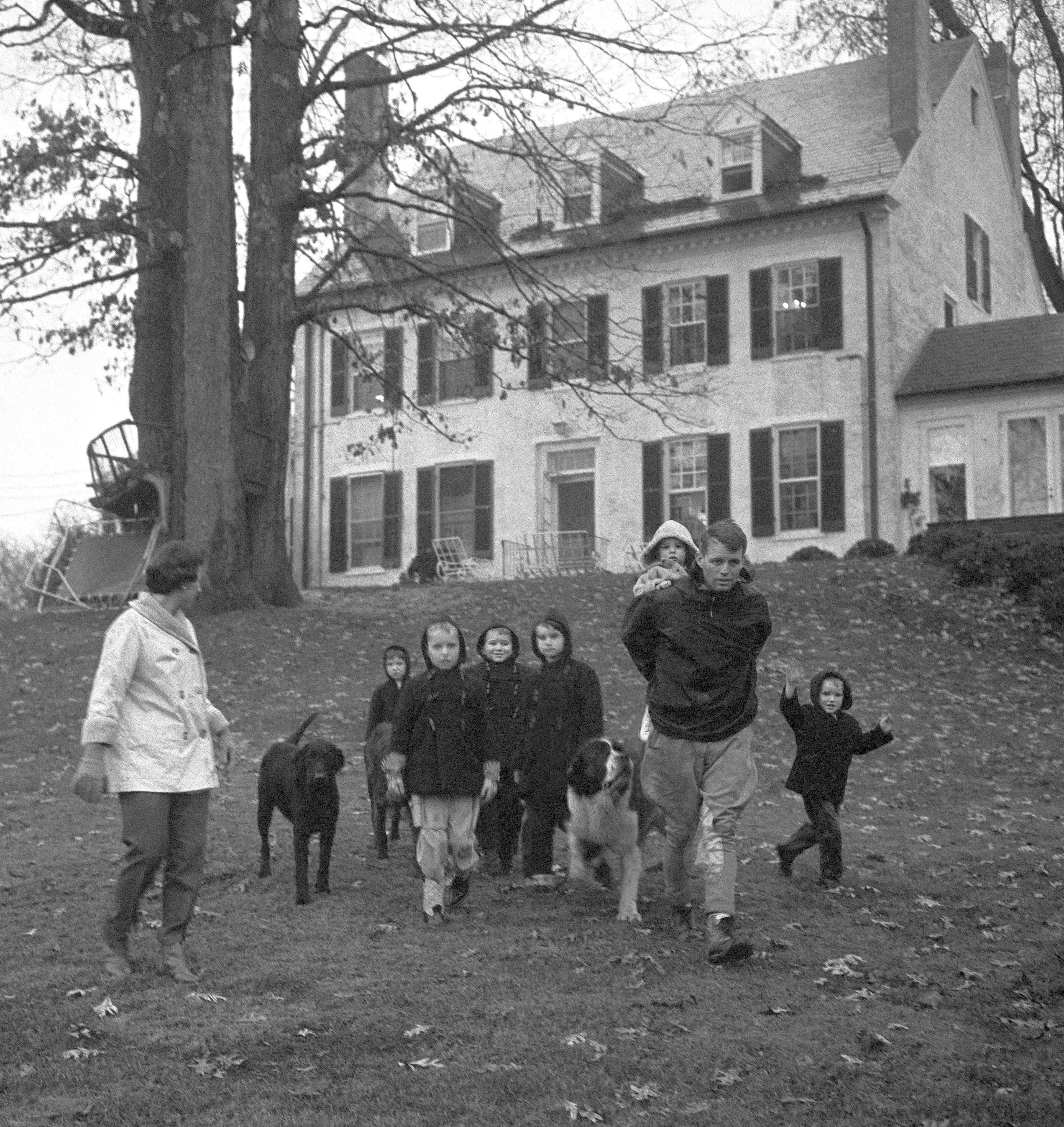 FILE - Mrs. Ethel Kennedy, from left, with children Courtney, 3, Kathleen, 8, Joseph Patrick, 7, Bobby, 5, husband Robert F. Kennedy, with one and a half-year-old Michael on his back, and David, 4, take a walk at the Kennedy home in McLean, Va., on Dec. 30, 1959. (AP Photo/Henry Griffin, File)