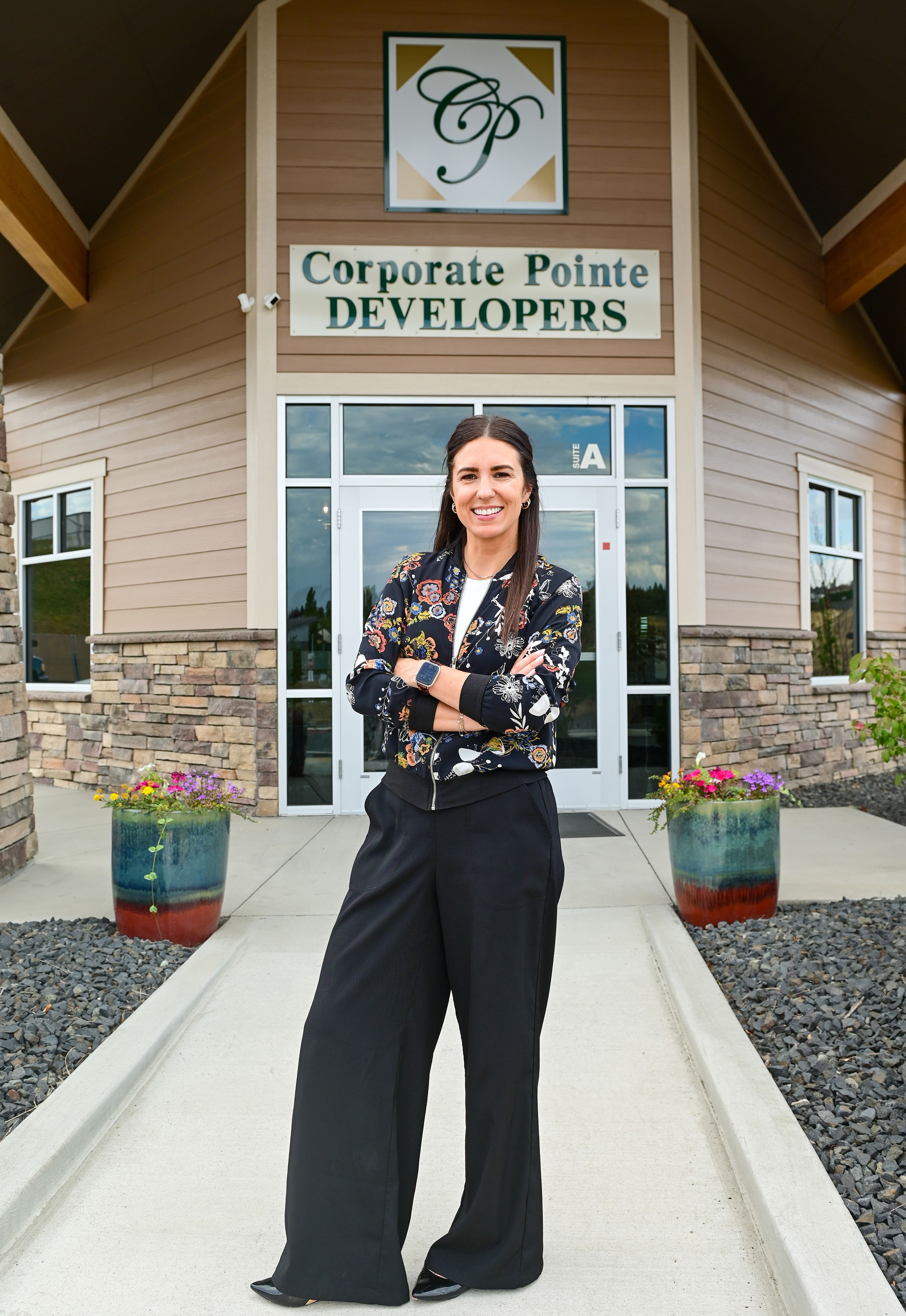 Nicole Morscheck stands outside of Corporate Pointe Developers in Pullman. Morscheck serves as the company's general manager, and is working to move into the role of president and managing member, a role her father has held at the company for decades.