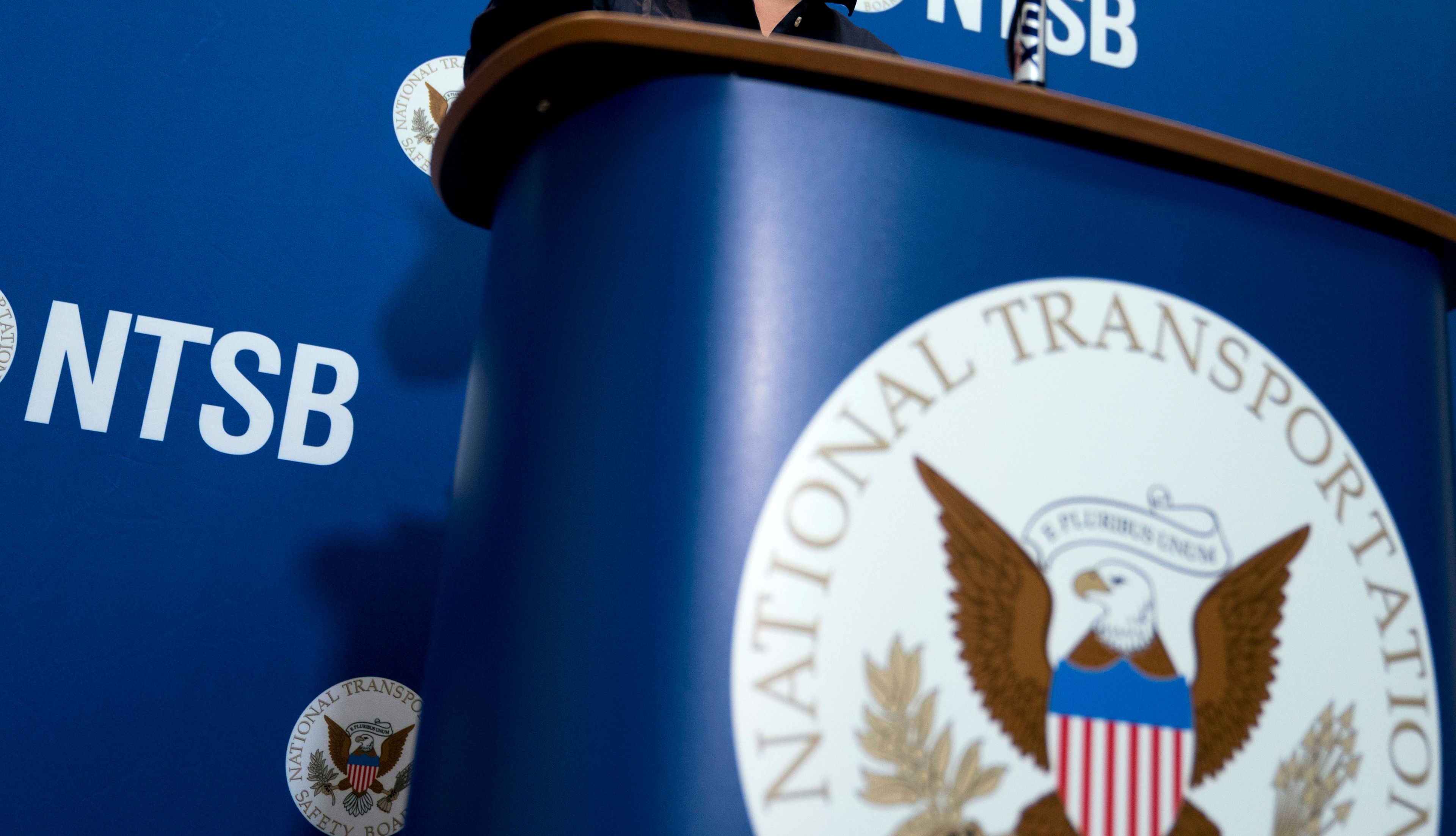 FILE - The National Transportation Safety Board logo and signage are seen at a news conference at NTSB headquarters in Washington, Dec. 18, 2017. Investigators said Thursday, June 6, 2024, that an incoming FedEx cargo plane came within less than 200 feet of hitting a Southwest Airlines jet last year in Austin, Texas, after both were cleared to use the same runway.