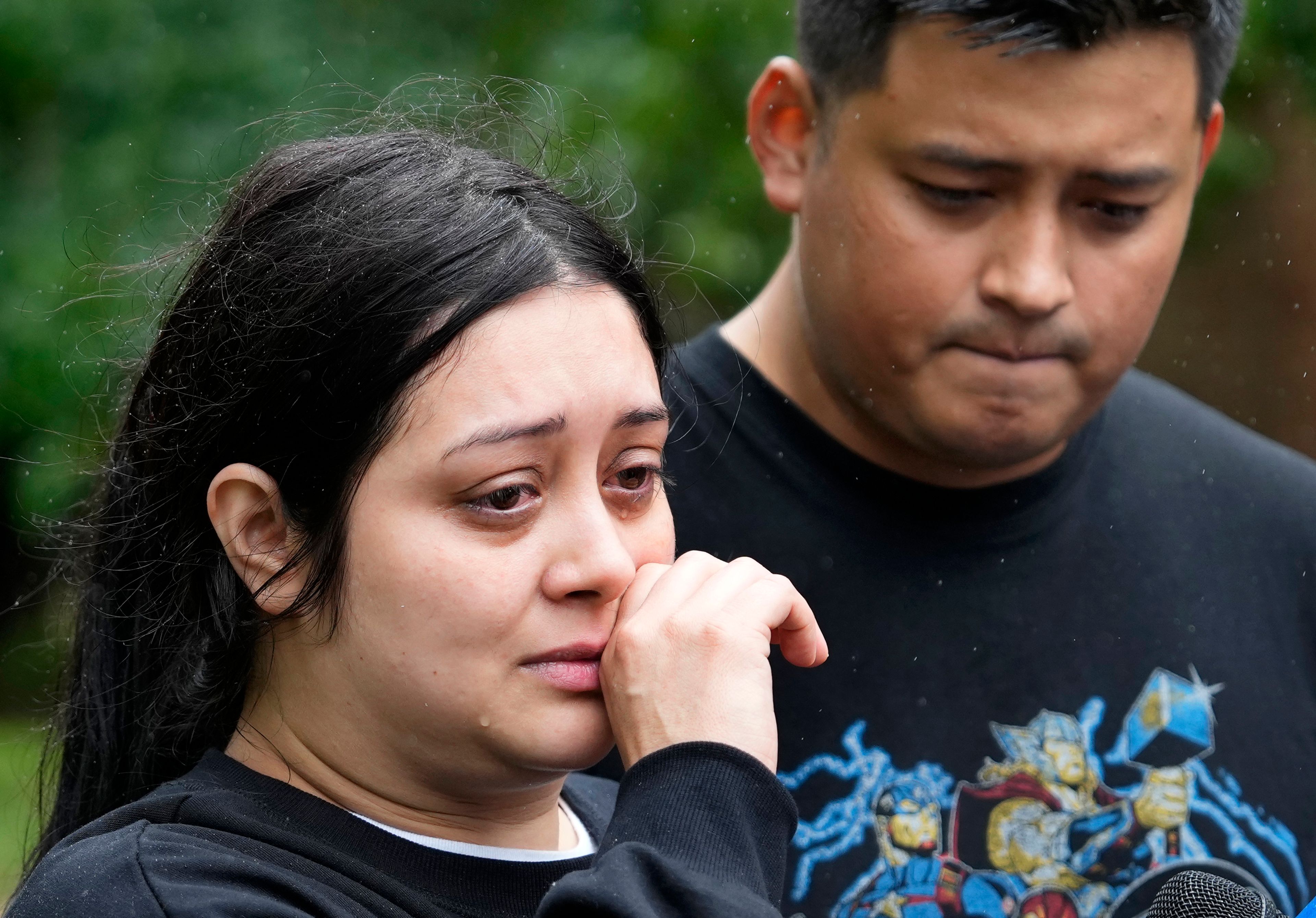 CORRECTION CORRECTS NAME Haley Loredo with her brother, Elmer Alvarado, wipes away tears outside her home in the 17400 block of Rustic Canyon Trail where her mother-in-law, Maria Loredo, 74, died after a tree fell on her second story bedroom during Hurricane Beryl, Monday, July 8, 2024, in Houston. (Melissa Phillip/Houston Chronicle via AP)