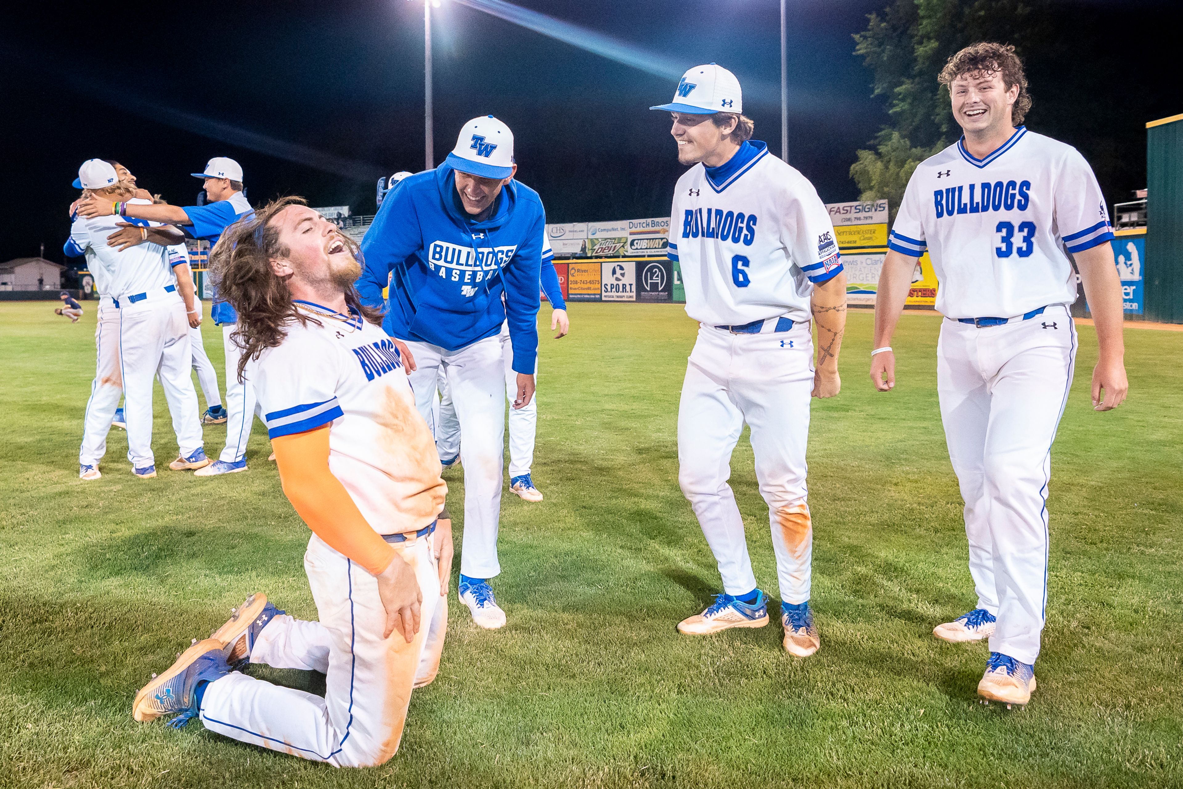 Tennessee Wesleyan’s Evan Magill, left, celebrates with teammates after scoring the game winning run during Game 18 of the NAIA World Series against Reinhardt on Thursday at Harris Field in Lewiston.