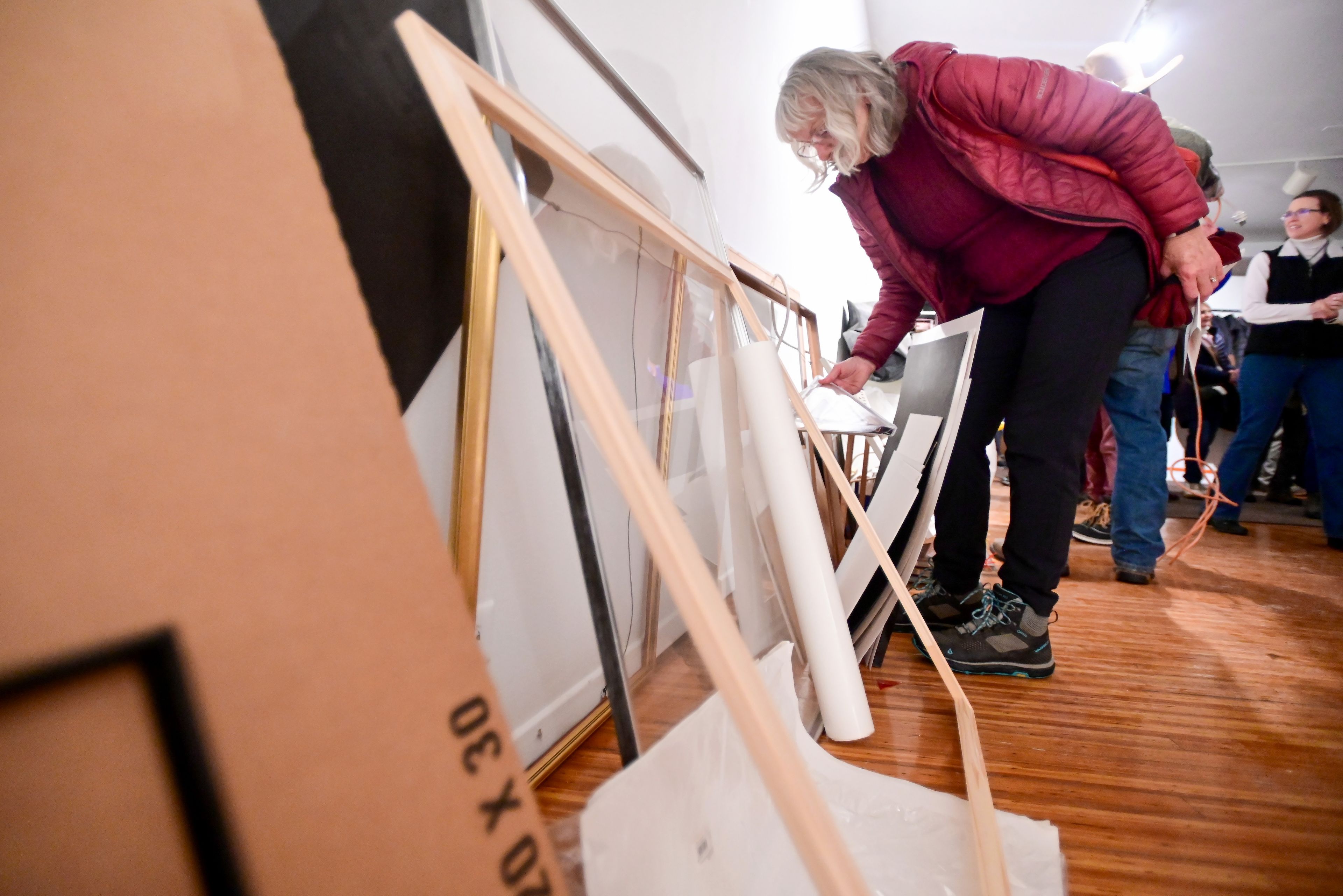 Elisabeth Brackney, of Moscow, looks through items laid out for visitors to take home for free from Moscow Contemporary on Thursday. The gallery held a town hall and closing concert that evening.