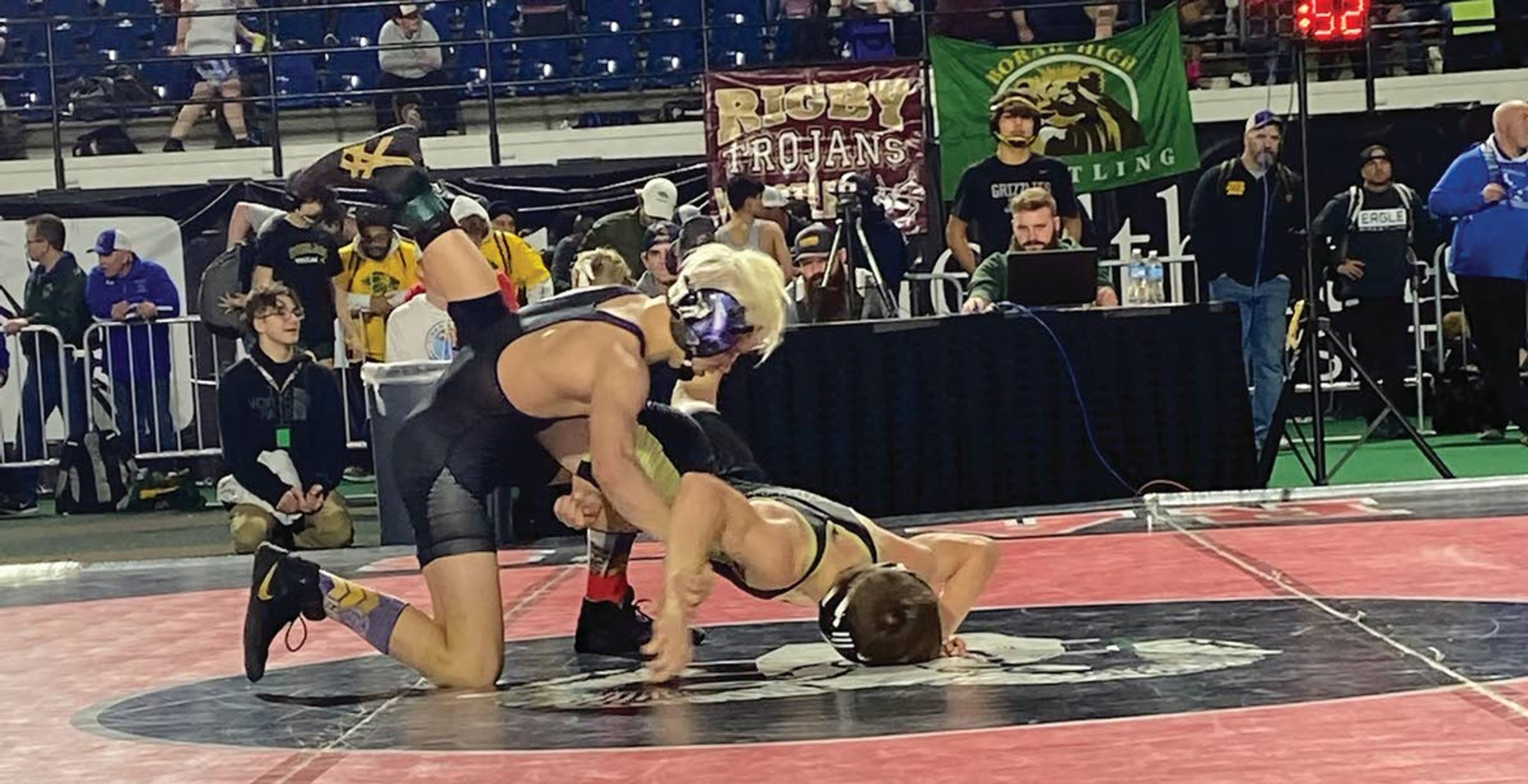 Lewiston sophomore Hoyt Hvass, left, wrestles during Saturday's action at the Idaho state wrestling tournament at Holt Arena. Hvass won the title at 120 pounds.