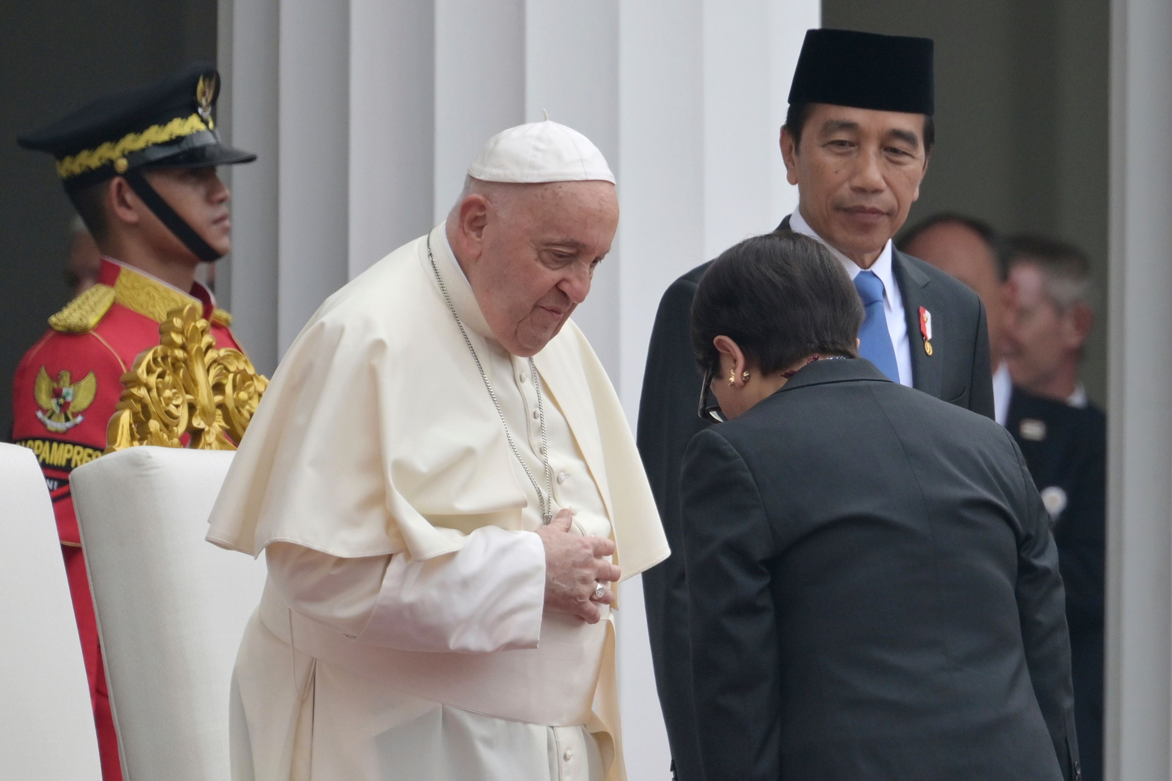 Pope Francis, center left, meets Indonesia's Foreign Minister Retno Marsudi, foreground, as Indonesia's President Joko Widodo, center right, looks on during a ceremonial welcome at the Presidential Palace in Jakarta Wednesday, Sept. 4, 2024.