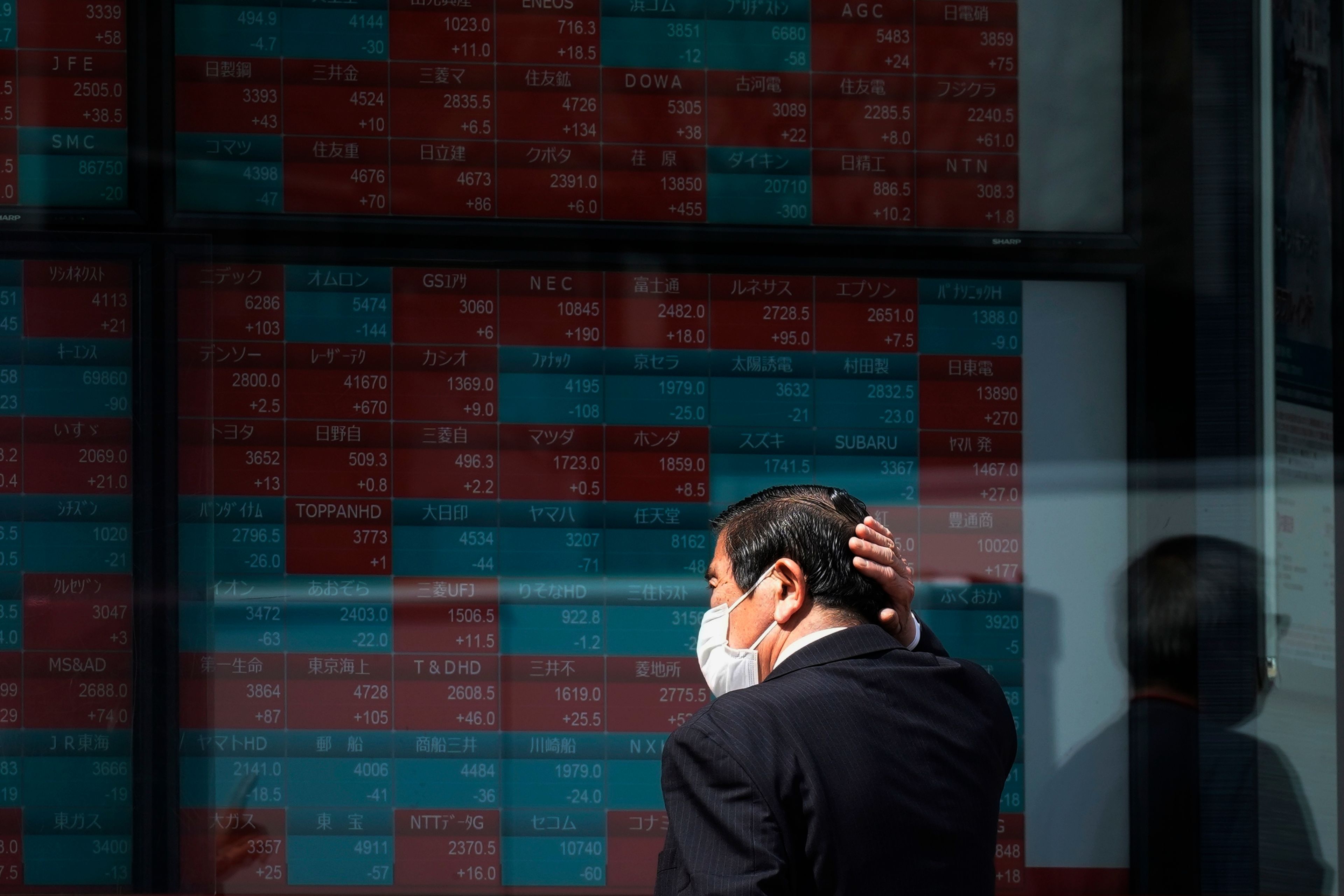 FILE - A person looks at an electronic stock board showing Japan's stock princes at a securities firm on April 2, 2024, in Tokyo. Asian markets were mixed on Monday, June 10, after a jobs report released Friday came in hotter than expected, while the euro fell after French President Emmanuel Macron dissolved the National Assembly following a setback in Sunday's parliamentary election.