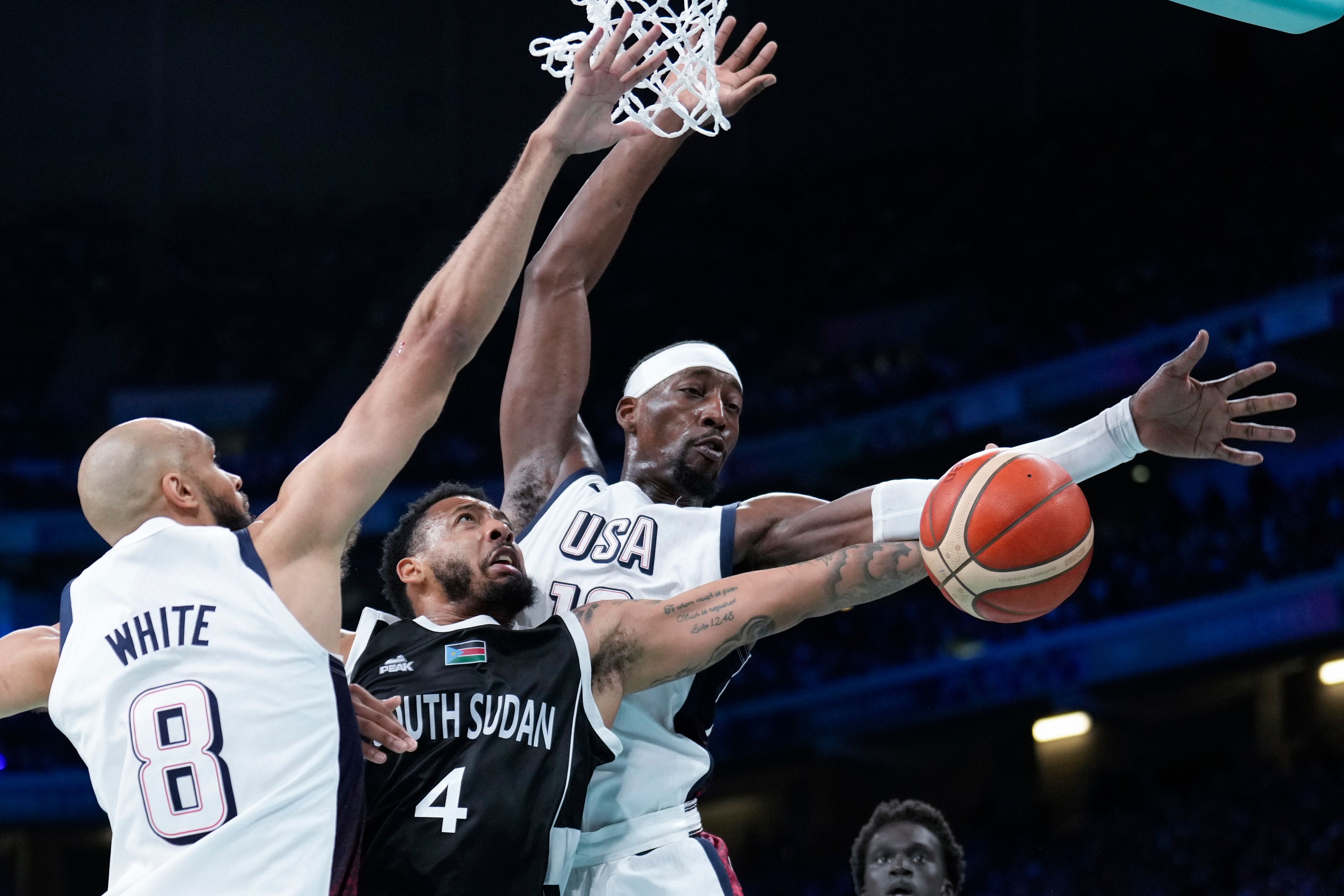 Carlik Jones, of South Sudan, shoots between Derrick White, (8) and Jayson Tatum, of the United States, in a men's basketball game at the 2024 Summer Olympics, Wednesday, July 31, 2024, in Villeneuve-d'Ascq, France. (AP Photo/Mark J. Terrill)