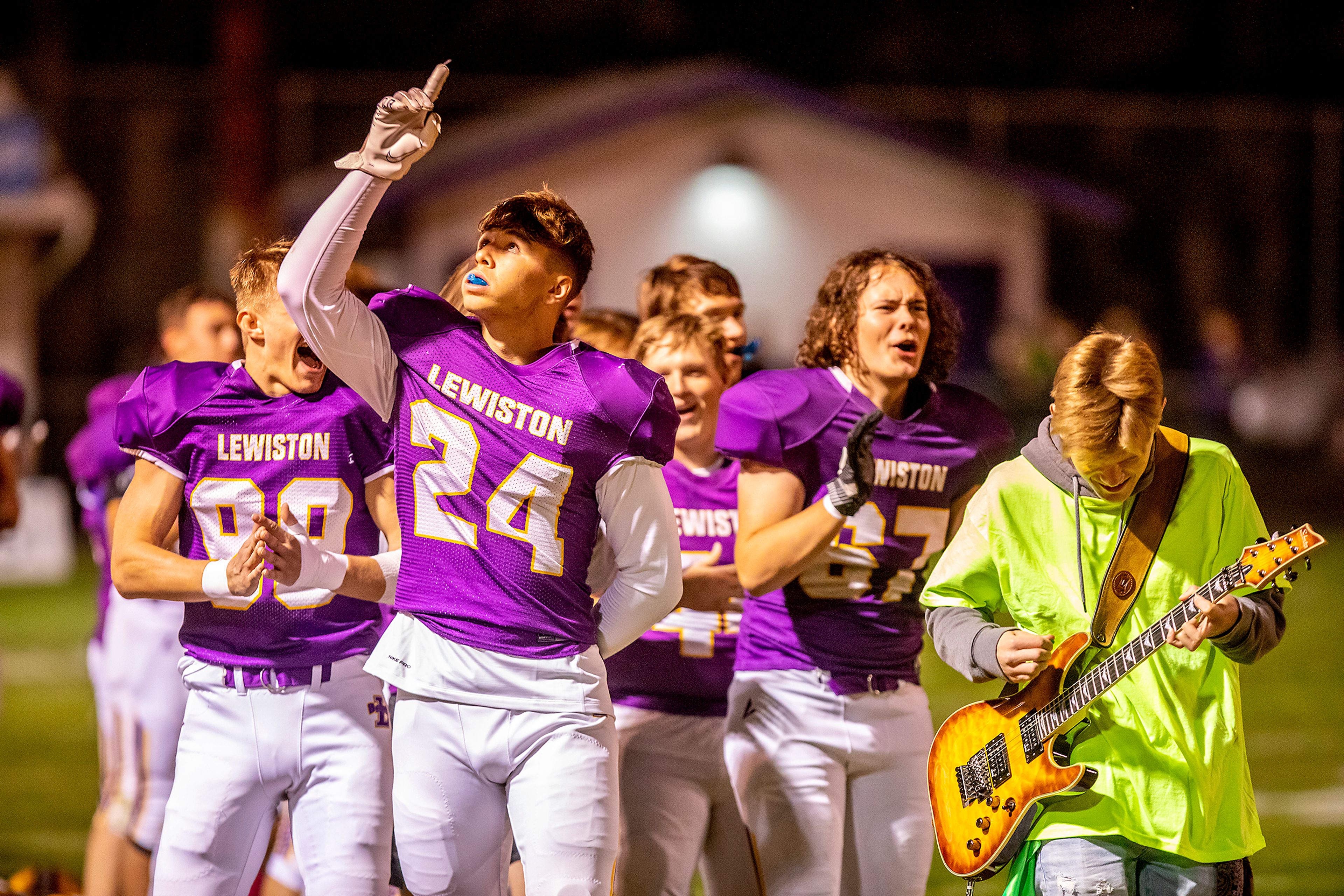 The Lewiston football team cheers as Alex Johnson (right) and Esten Lee (not pictured) finish their rock rendition of the national anthem at Bengal Field on Nov. 8, 2021. The Bengals would move to reinvented 5A classification with Moscow, Lakeland and Sandpoint under the new classification.