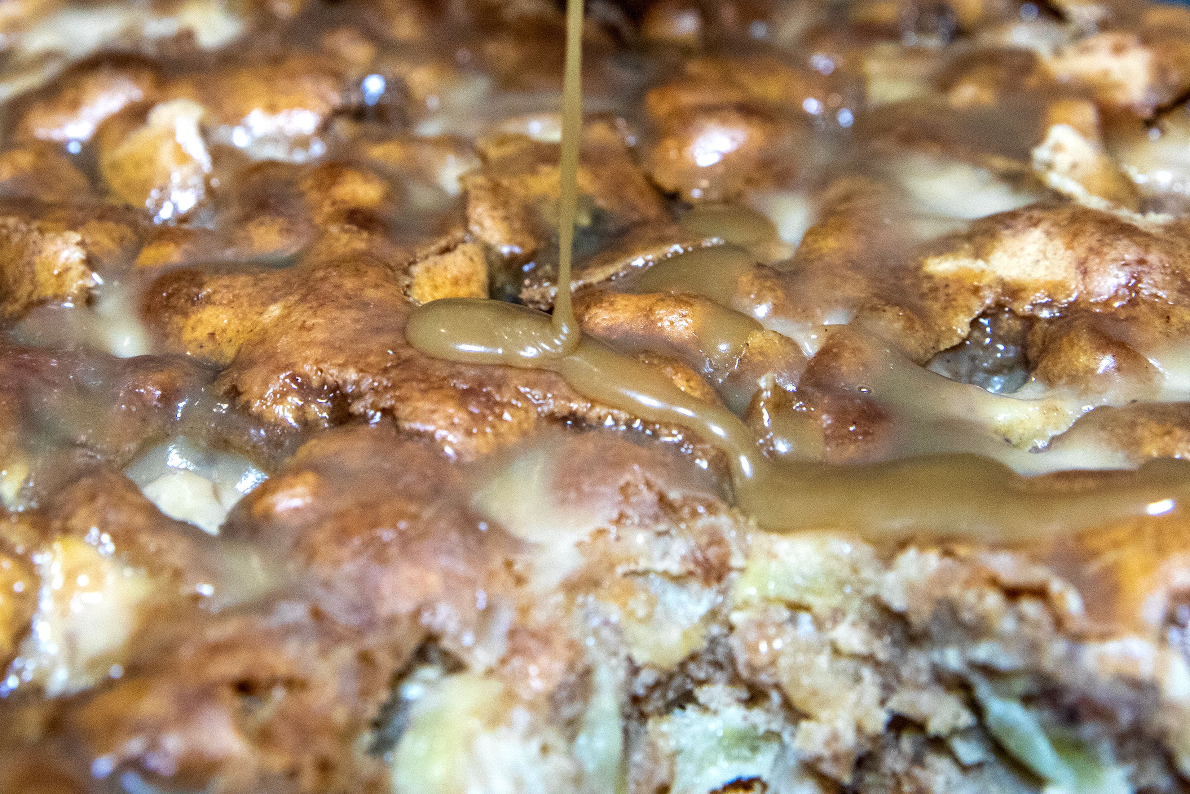 Butterscotch syrup is drizzled over an apple cake Thursday, Dec. 14, in Lewiston.