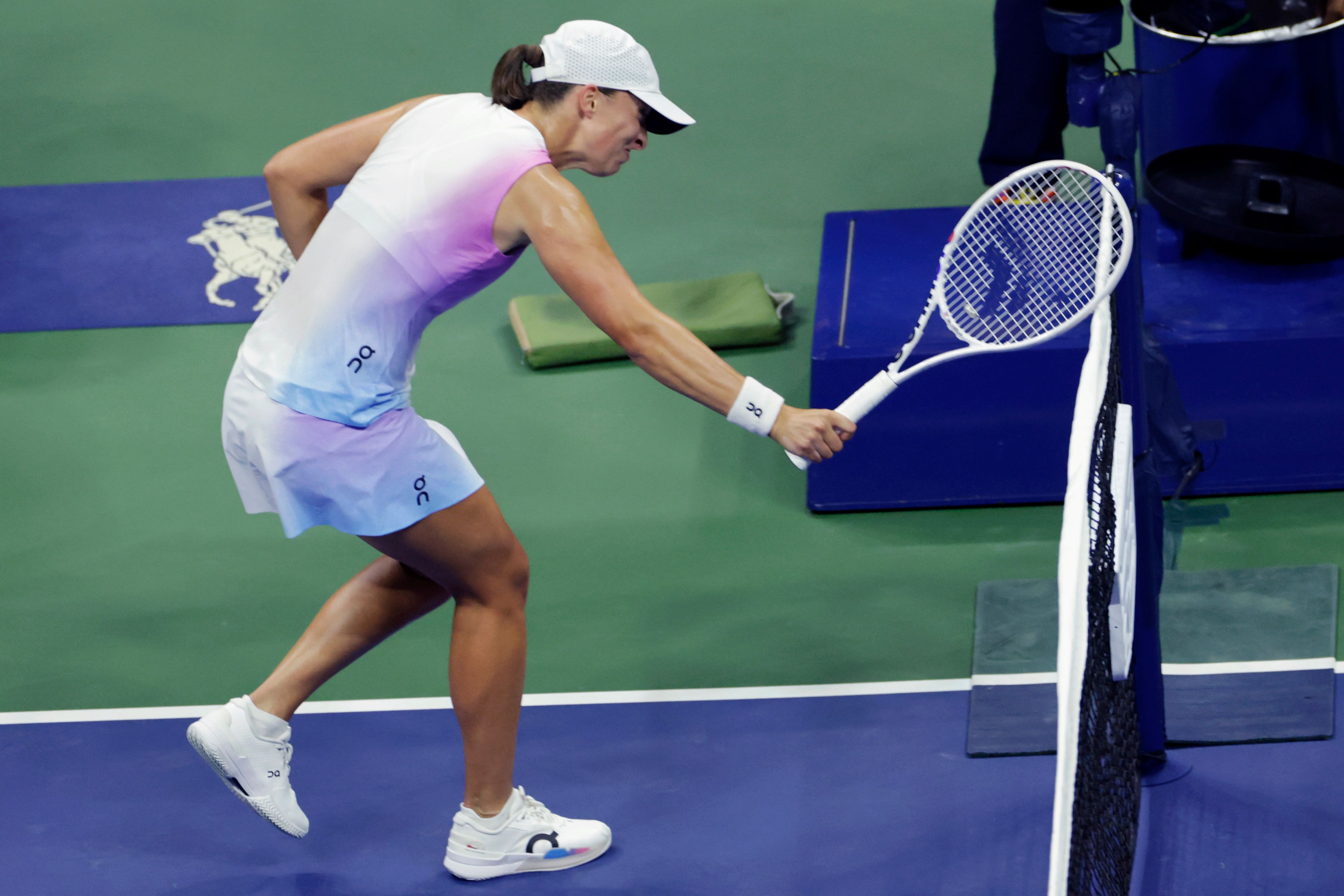 Iga Świątek, of Poland hits the net with her racquet after losing a point to Jessica Pegula, of the United States during the quarterfinals of the U.S. Open tennis championships, Wednesday, Sept. 4, 2024, in New York.