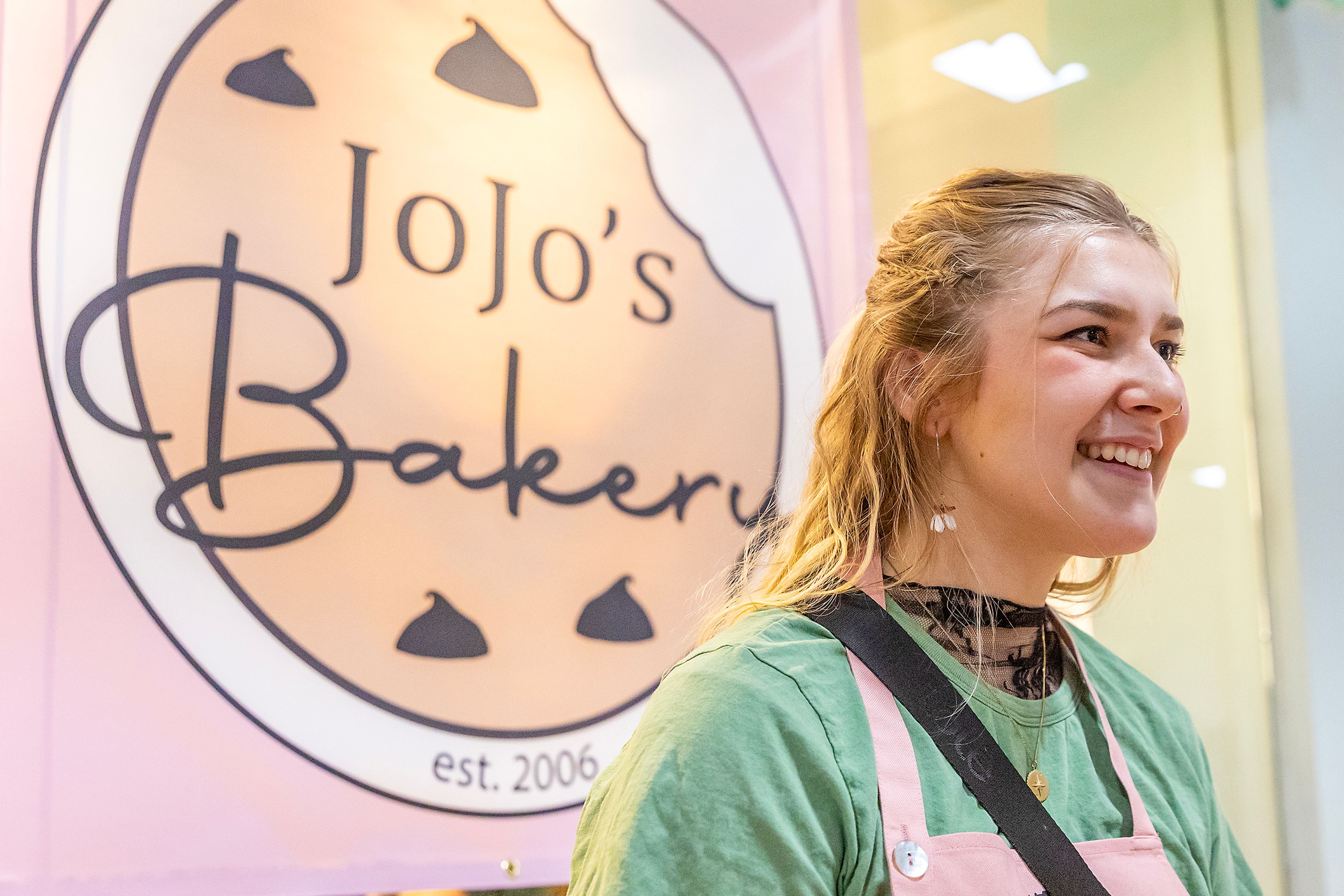 Josephine Reed talks about holiday shopping at her booth, JoJo’s Bakery, Friday at the Christmas Market at the Lewiston Center Mall. 