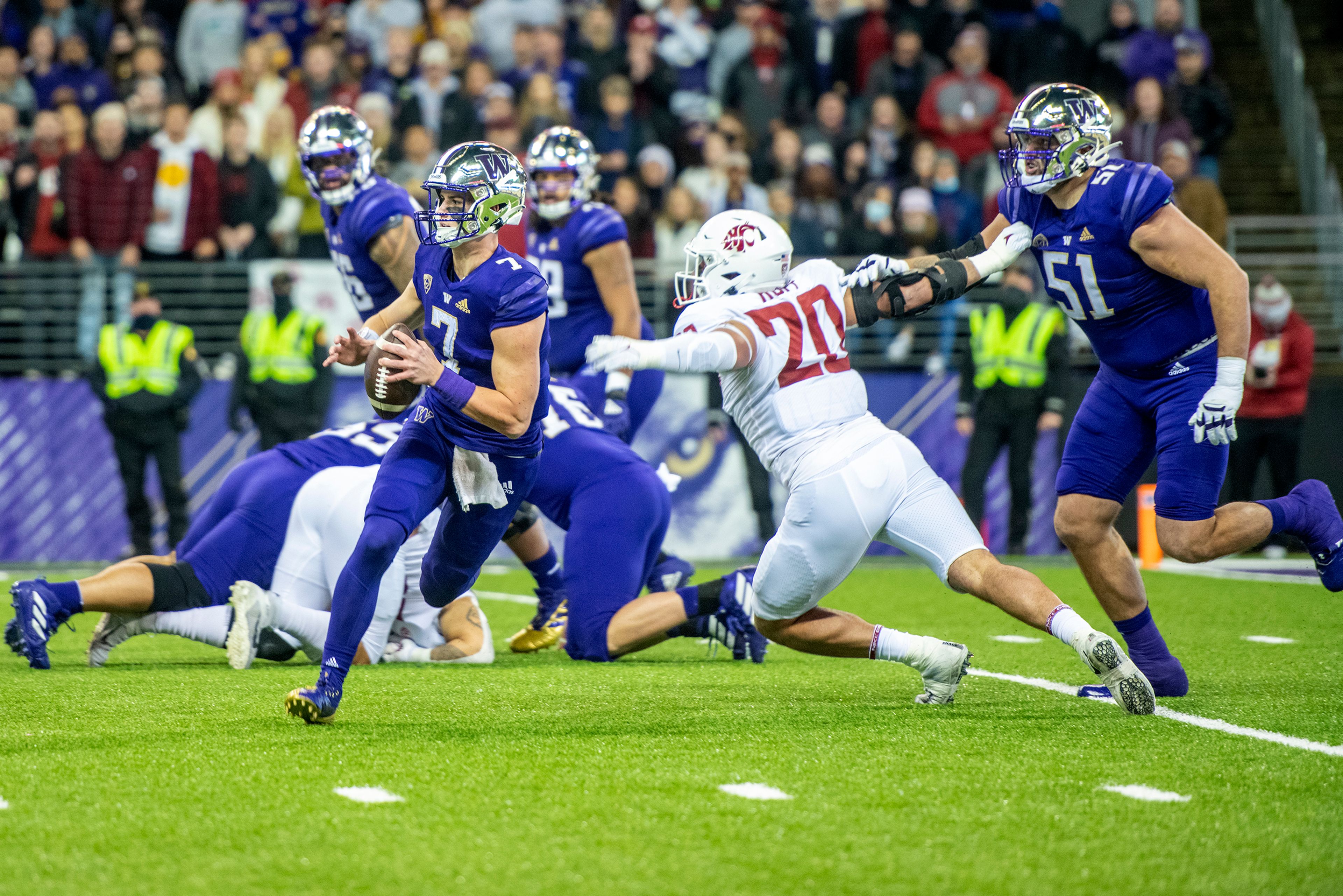 Washington State Cougars defensive end Quinn Roff (20) rushes Washington Huskies quarterback Sam Huard (7) during the first quarter of an Apple Cup at Husky Stadium in Seattle. 