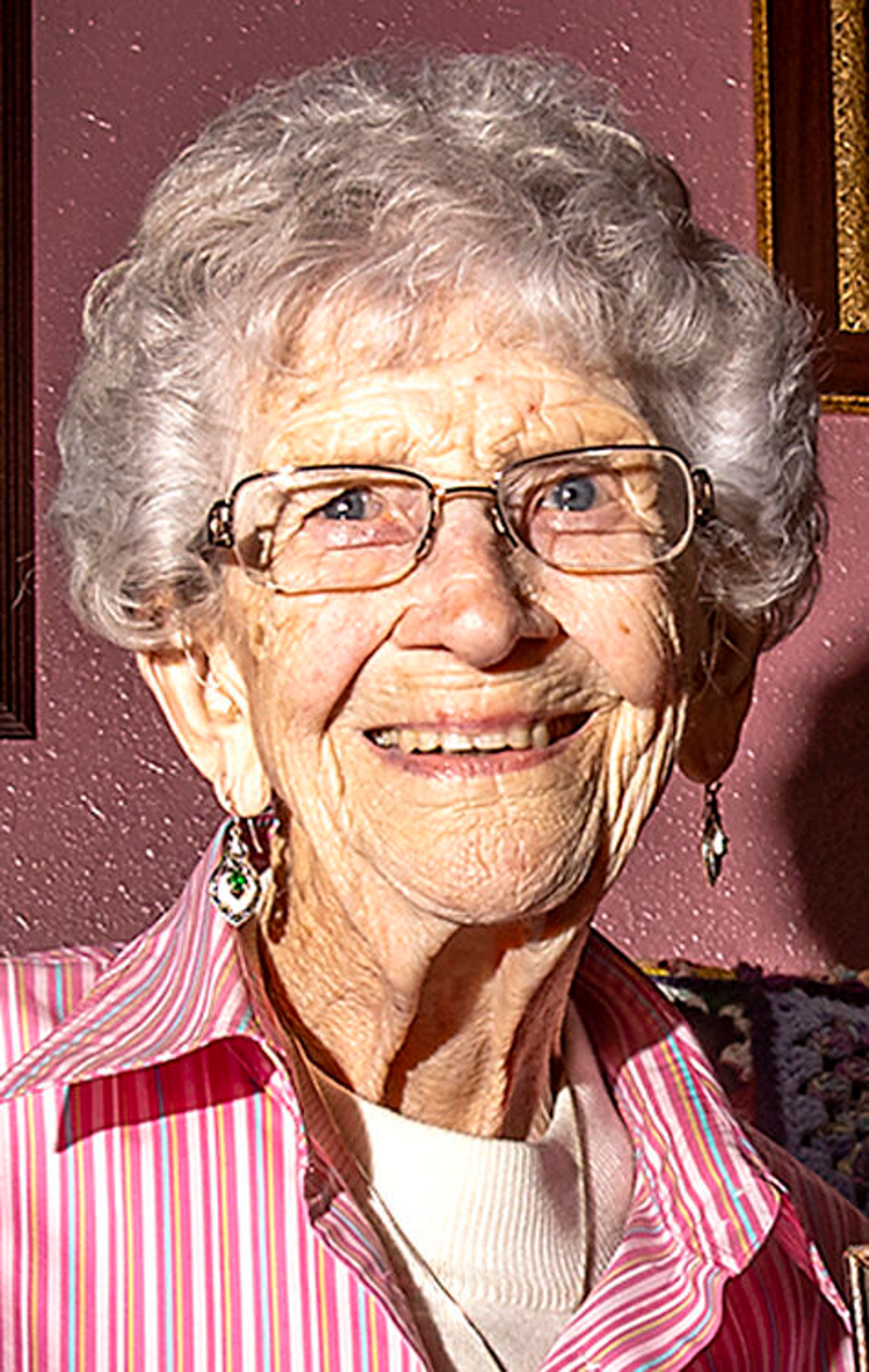 Mildred Channel sits on the couch for a portrait holding a picture of her and her mom, Constance Ida Windgad, when she was around 3 months old on Wednesday, May 5, in Lewiston. Channel celebrates her 100th birthday on ___