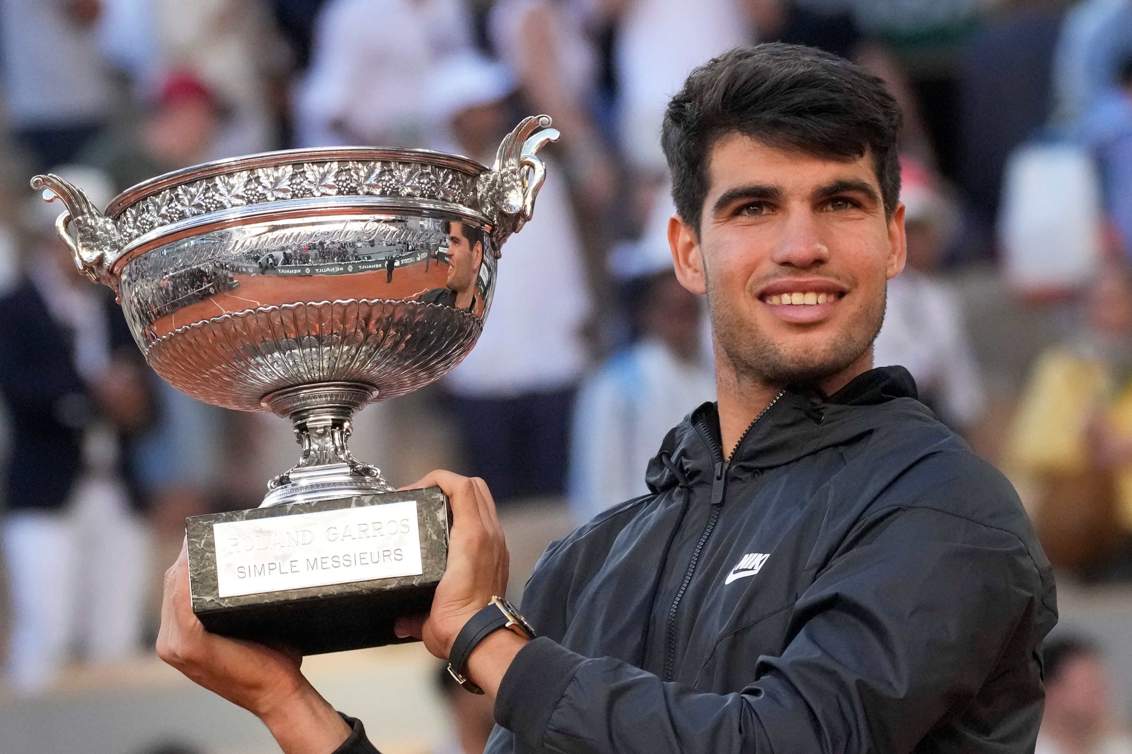 Spain's Carlos Alcaraz holds the trophy after winning the men's final of the French Open tennis tournament against Germany's Alexander Zverev at the Roland Garros stadium in Paris, France, Sunday, June 9, 2024.