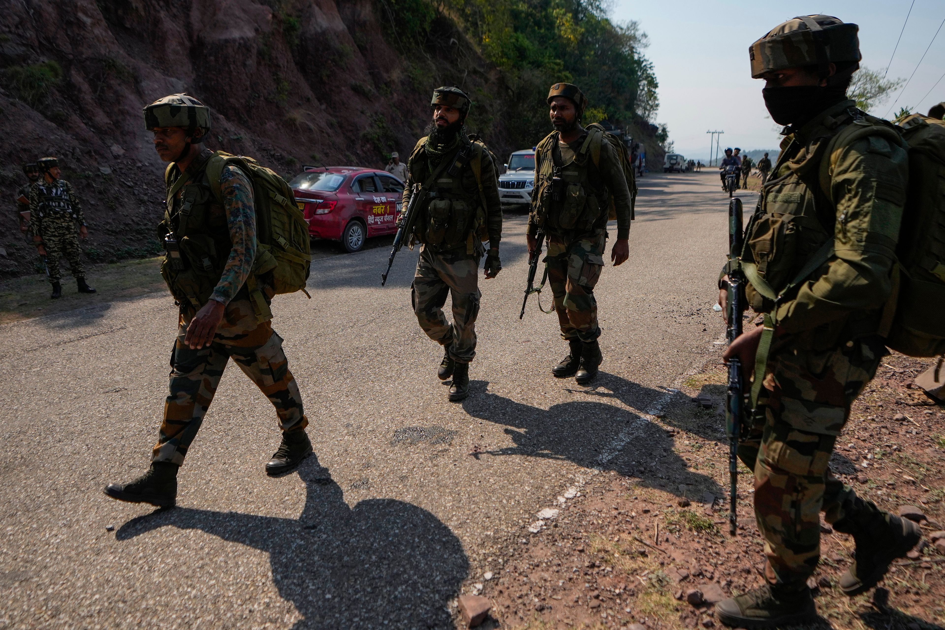 Indian army soldiers patrol the area where a bus fell into a deep gorge on Sunday after being fired at by suspected militants in Reasi district, Jammu and Kashmir, Monday, June 10, 2024. The bus was carrying pilgrims to the base camp of the famed Hindu temple Mata Vaishno Devi when it came under attack killing at least nine people.