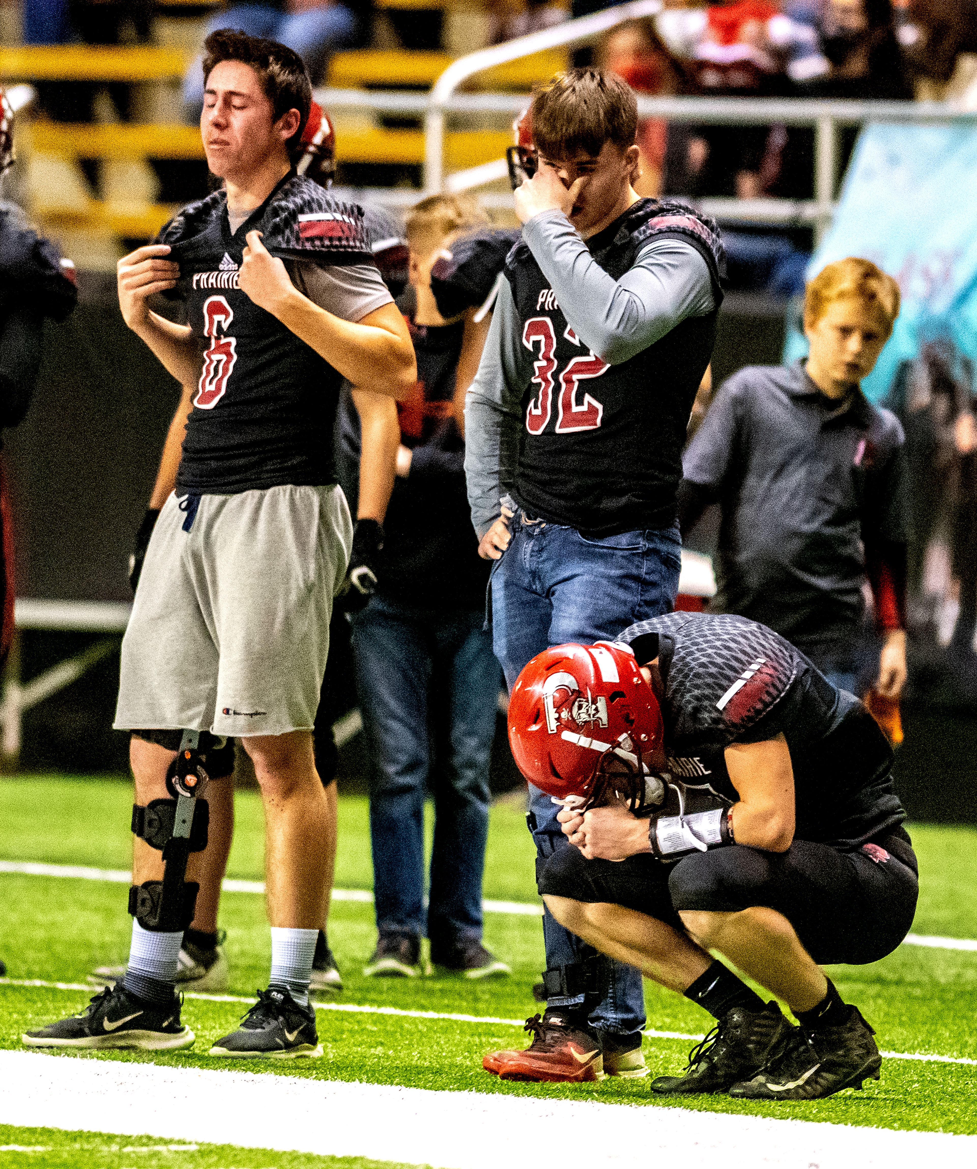 Prairie players on the sidelines react to Dean Johnson breaking his ankle and being forced to exit the game. The Prairie Pirates lost to the Oakley Hornets 42-40 in the Class 1A Division O state semifinal football game at the Kibbie Dome in Moscow on Friday.