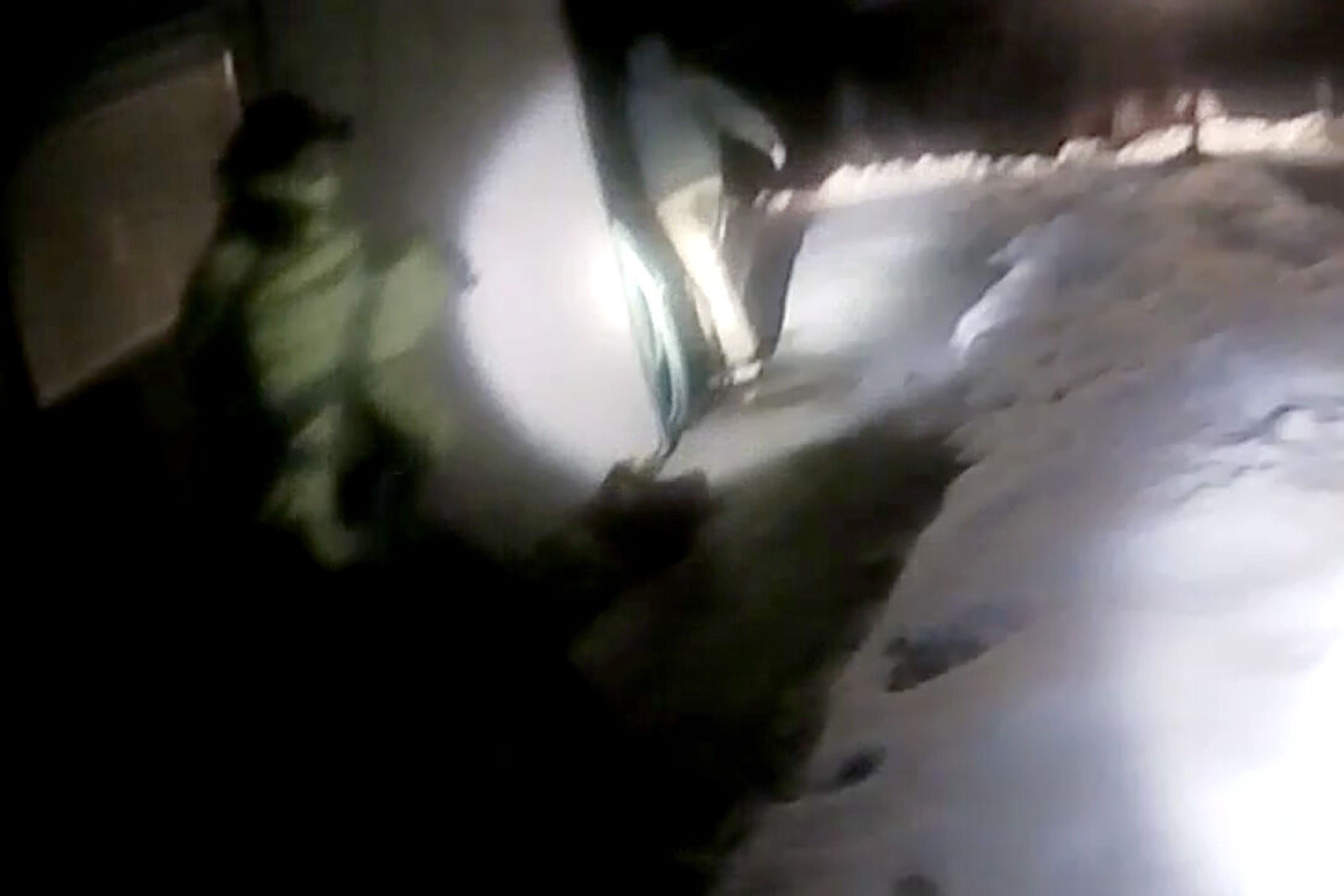 Michael J. Trappett goes around a corner of his parents' house in this image taken from an officer's body camera footage. Moments after this image, Trappett was shot and killed by the officers after turning toward them with the knife held up in his right hand.