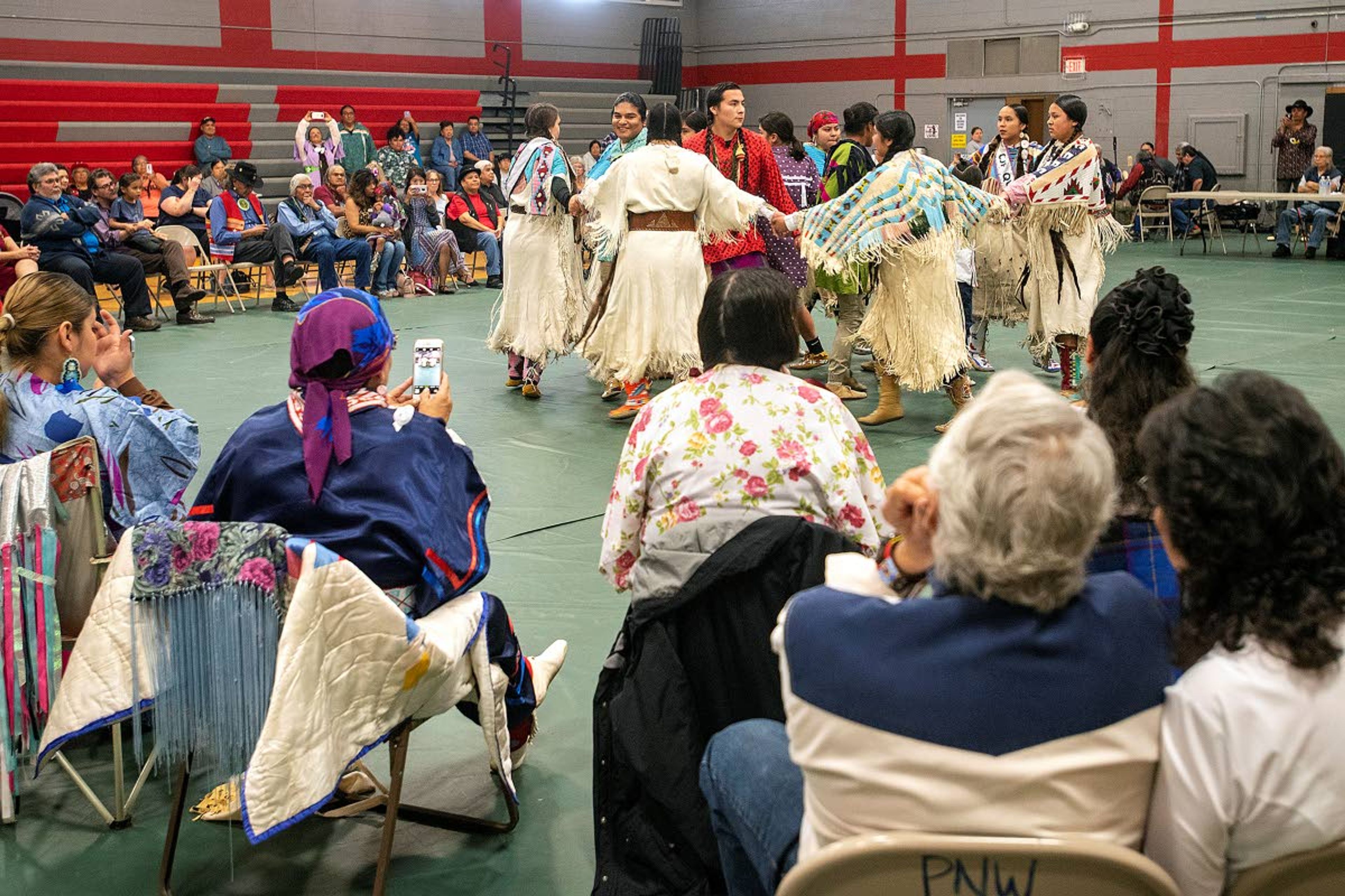 Young dancers, all descendants of the late Alex Pinkham, Sr., perform the Moonlight Dance during a ceremony on honoring Pinkham for his service in World War II on Saturday afternoon at the Pi-Nee-Waus Community Center in Lapwai.