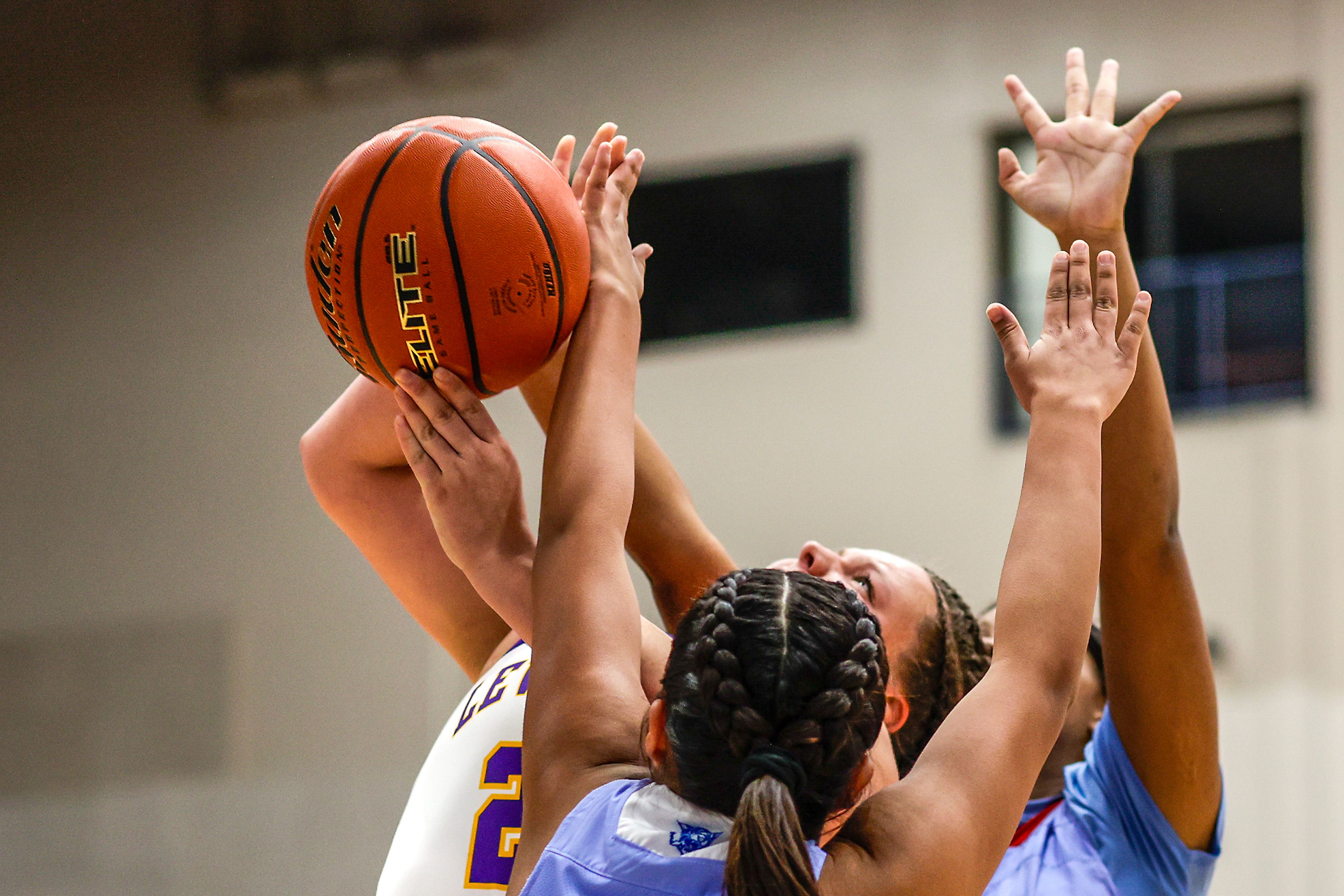 Lewiston post Lillian Samuels tries to break through the defense of Lapwai shooting guard Madden Bisbee, front, and Qubilah Mitchell to get to the basket during the Avista Holiday Tournament on Wednesday.