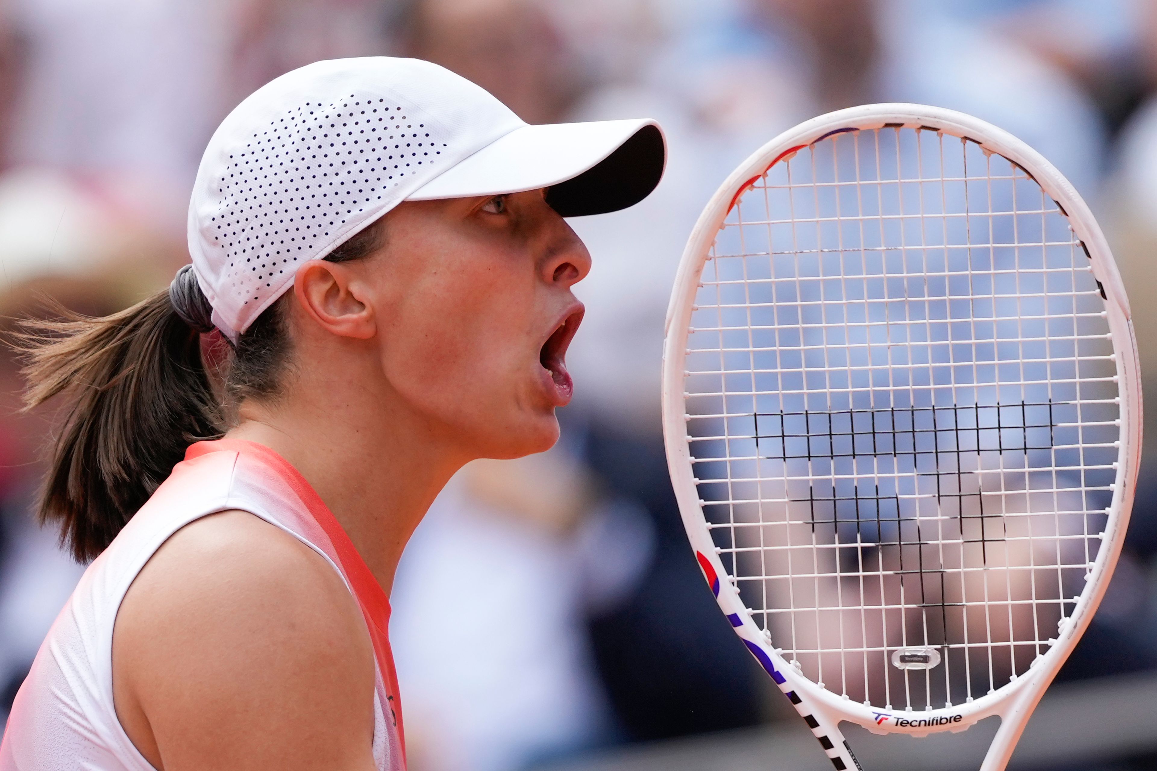 Poland's Iga Swiatek screams after winning the first set against Italy's Jasmine Paolini during the women's final of the French Open tennis tournament at the Roland Garros stadium in Paris, France, Saturday, June 8, 2024.