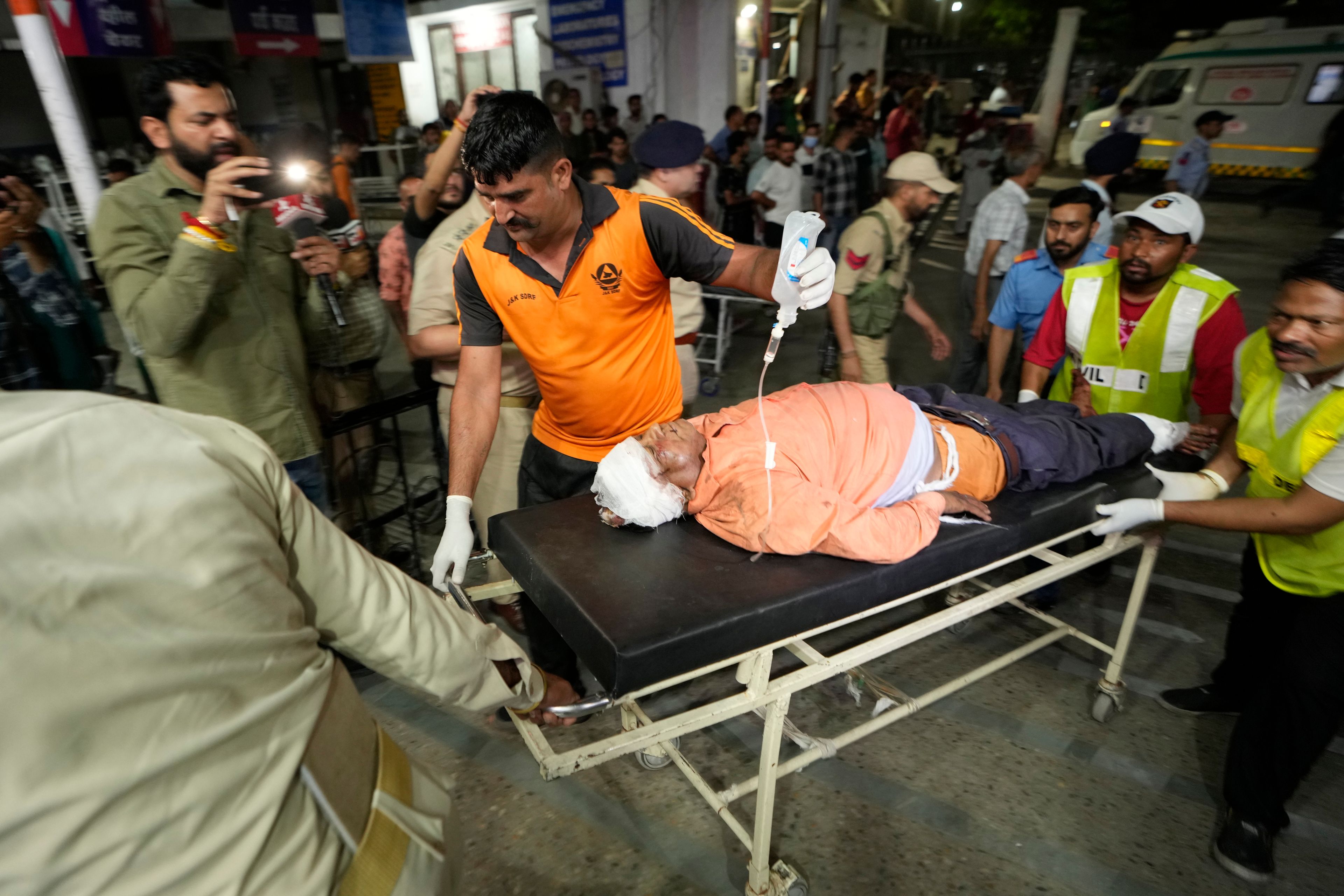 An injured man is brought to the Government Medical College Hospital in Jammu after the bus he was traveling in fell into a deep gorge in the Pouni area of Jammu's Reasi district, India, Sunday, June 9, 2024. Officials in Indian-controlled Kashmir say at least nine people have been killed after suspected militants fired at a bus with Hindu pilgrims, which then fell into a deep gorge.