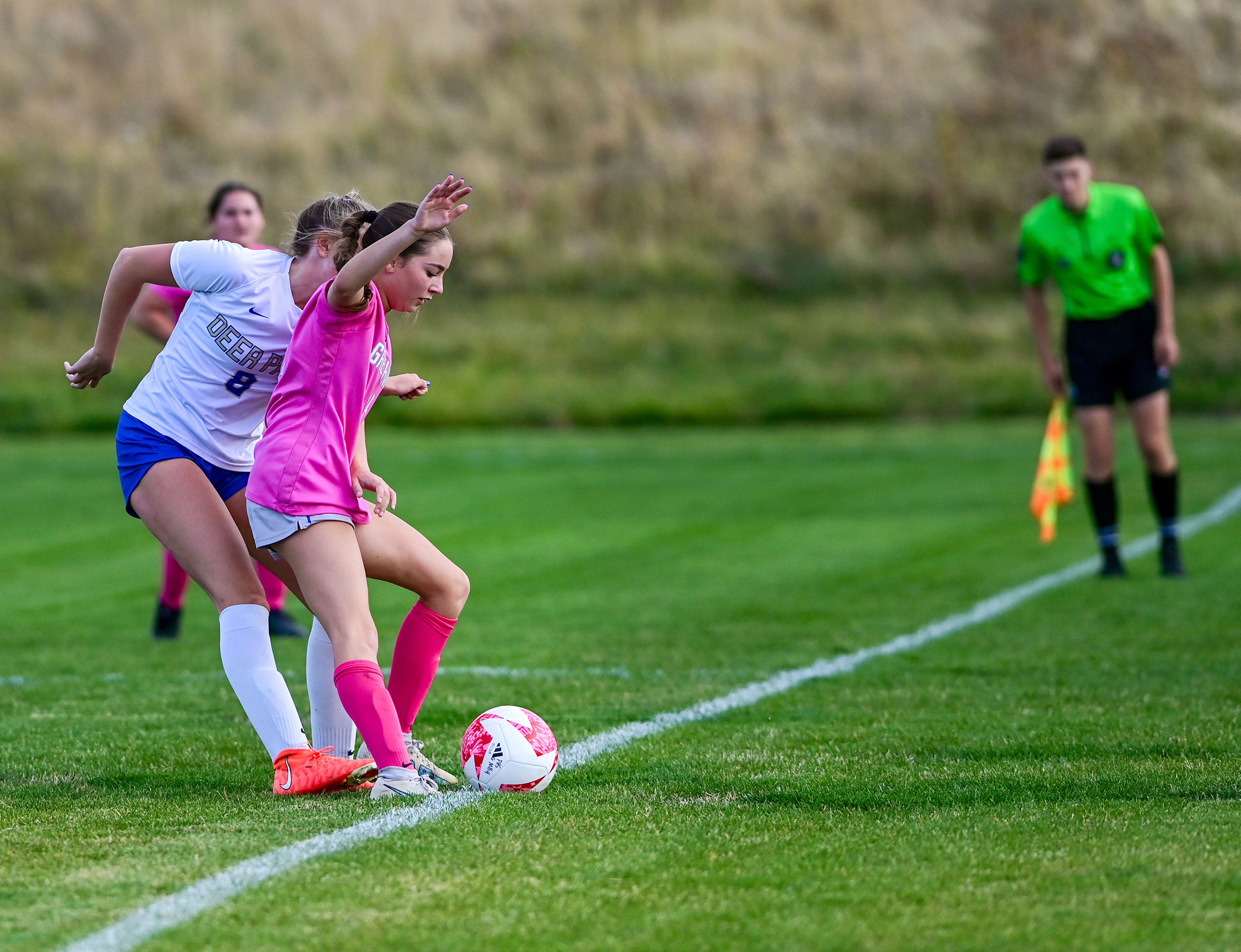 Pullman freshman Vicky Villarino nears a touchline while being guarded from behind by Deer Park Raigan Coolbaugh Thursday in Pullman.,