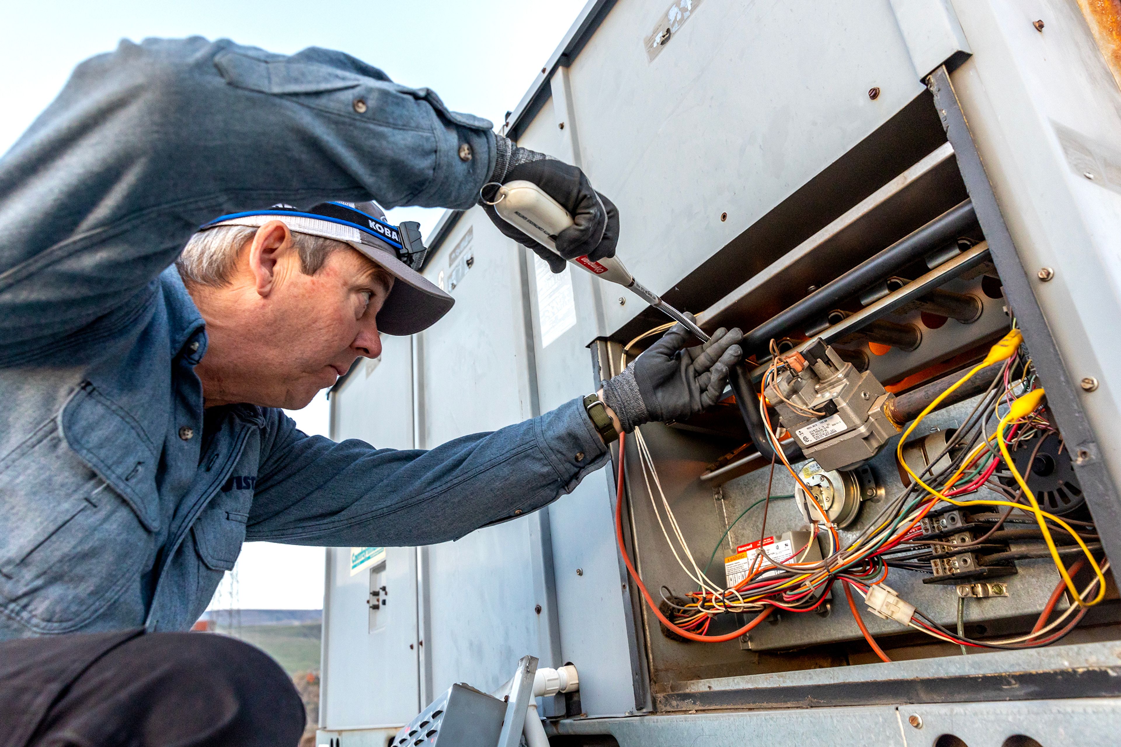 Jon May puts works to relight the gas at the Lewiston Tribune building Tuesday in Lewiston.