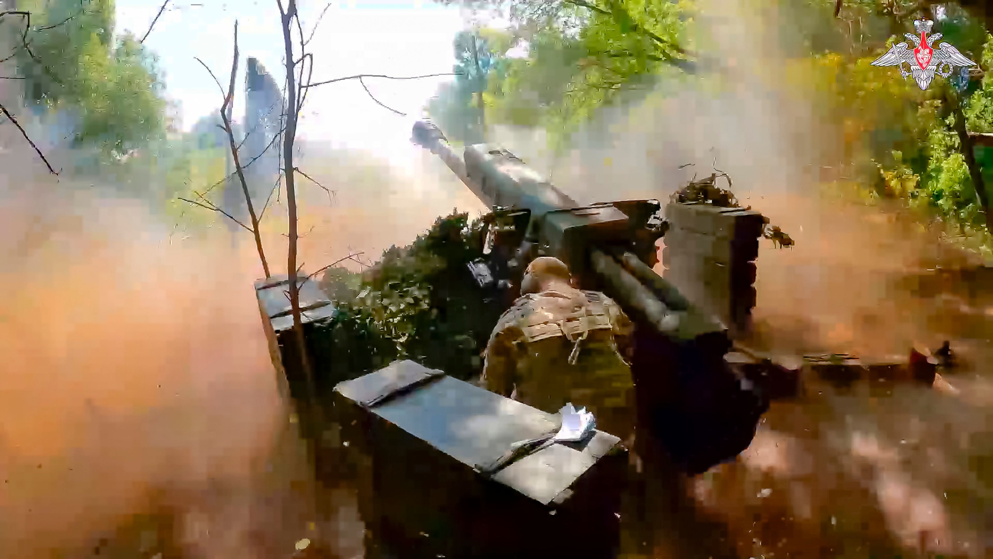 In this photo taken from video released by the Russian Defense Ministry on Wednesday, Aug. 7, 2024, a Russian soldier fires from D-30 howitzer towards Ukrainian positions in an undisclosed location in Ukraine. (Russian Defense Ministry Press Service via AP)