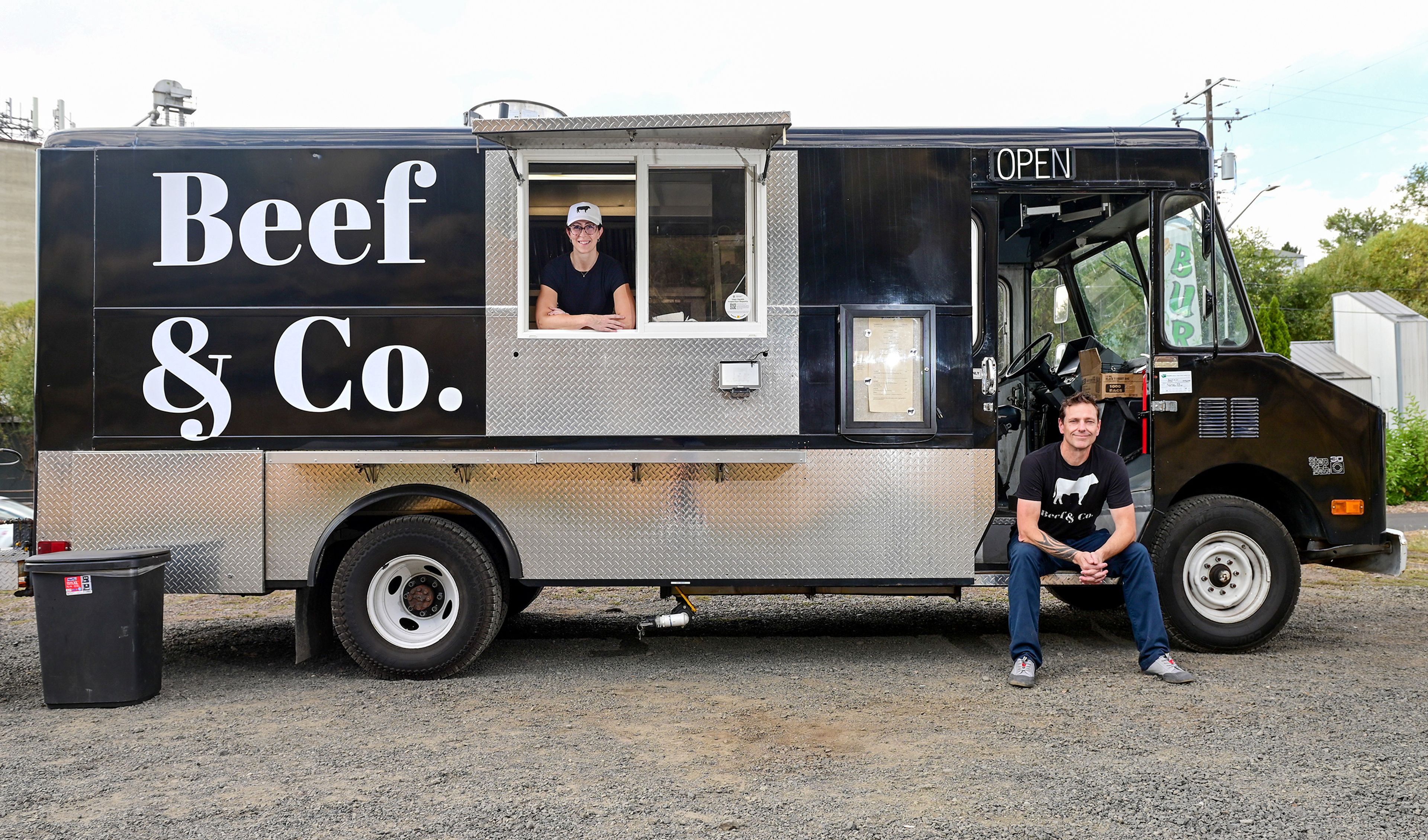 Beef and Co. owners Marie Perry, left, and Anthony Walls, pose at their new tri-tip sandwich truck in Pullman.