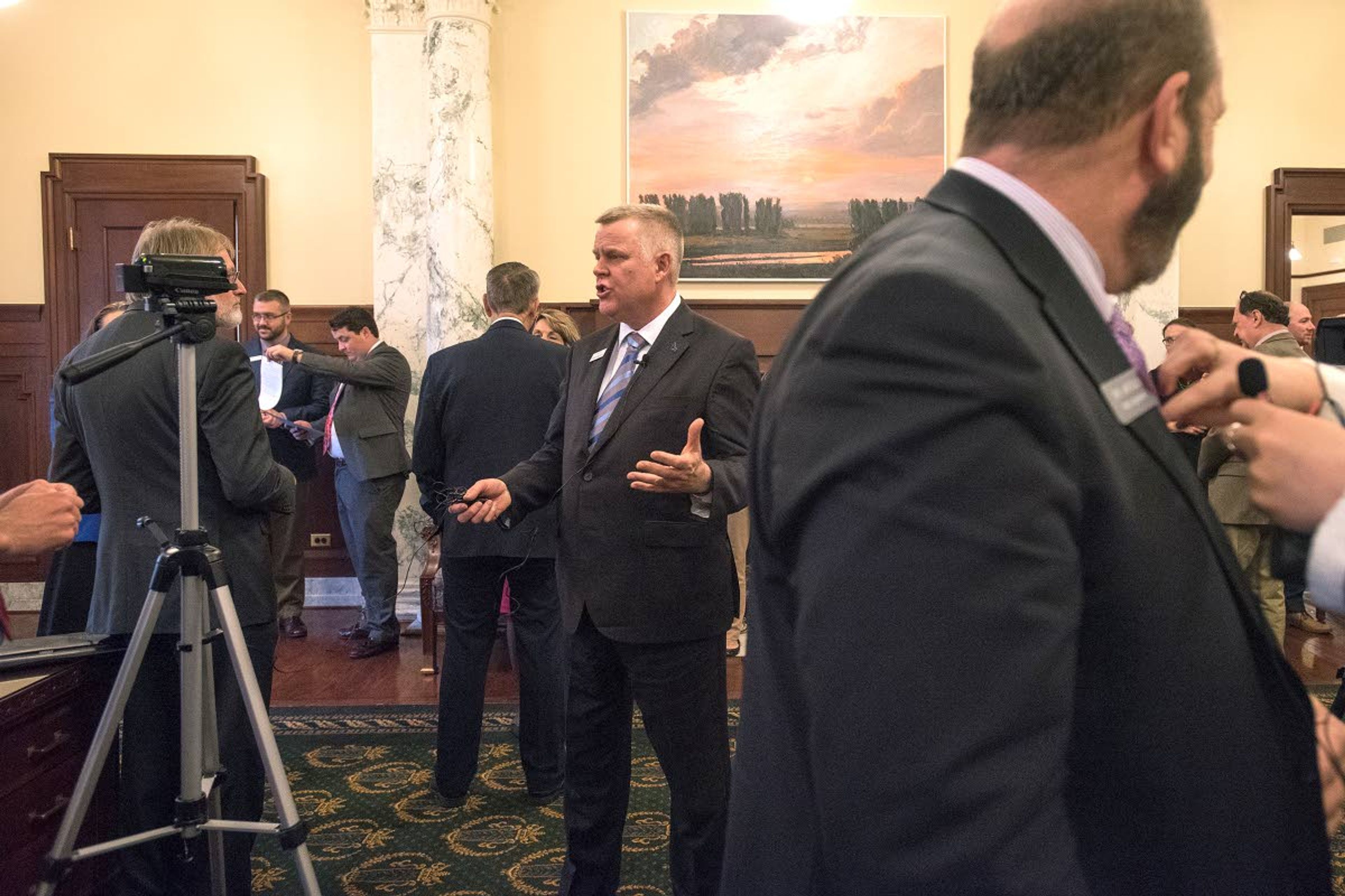 Idaho Sen. Dave Nelson, D-Moscow, center, answers questions during an interview as Idaho Rep. Jake Ellis, D-Boise, right, prepares to give an interview for a local television station after a bill signing ceremony in the governor's office last month at the Idaho State Capitol Building in Boise.