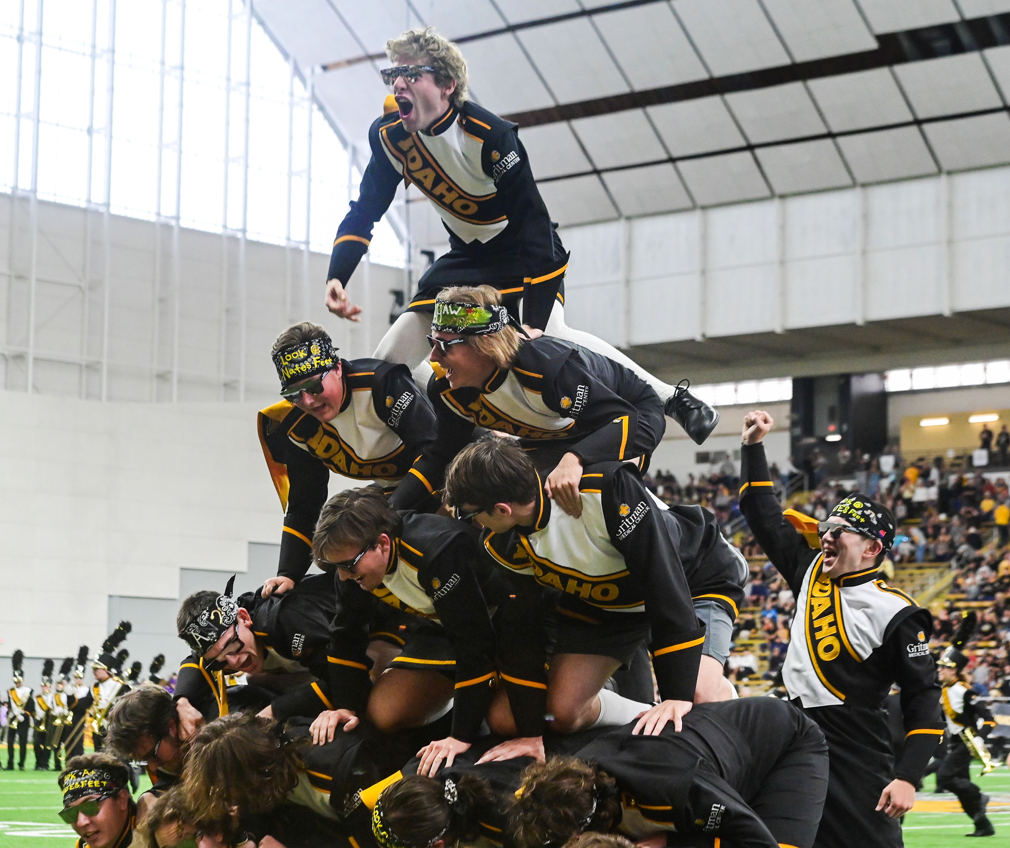 The tuba section of the Vandal Marching Band create a human pyramid before the start of a game against Northern Arizona Saturday at the P1FCU Kibbie Dome in Moscow.,