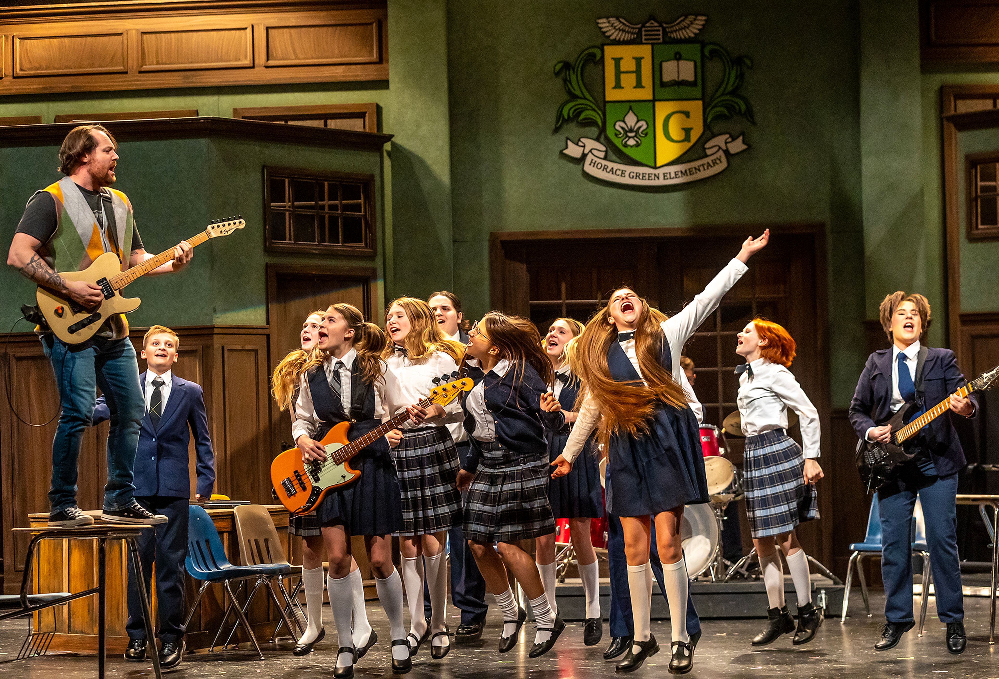 TJ Richardson plays guitar as students dance during a rehearsal for the Civic Theatre production of School of Rock Tuesday, May 21, in Lewiston.