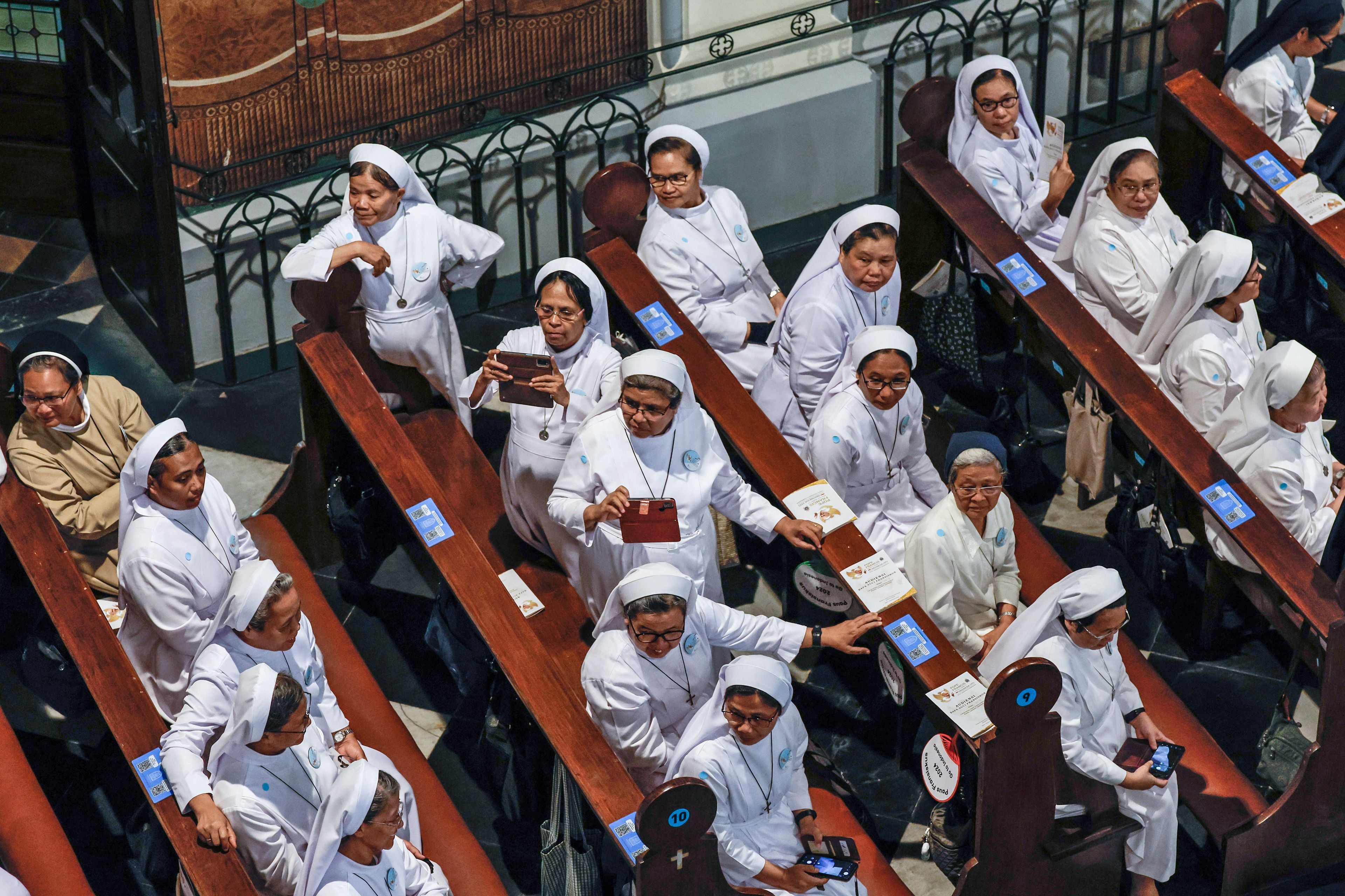 Nuns wait for the arrival of Pope Francis at the Jakarta Cathedral in Jakarta, Indonesia, Wednesday, Sept. 4, 2024.