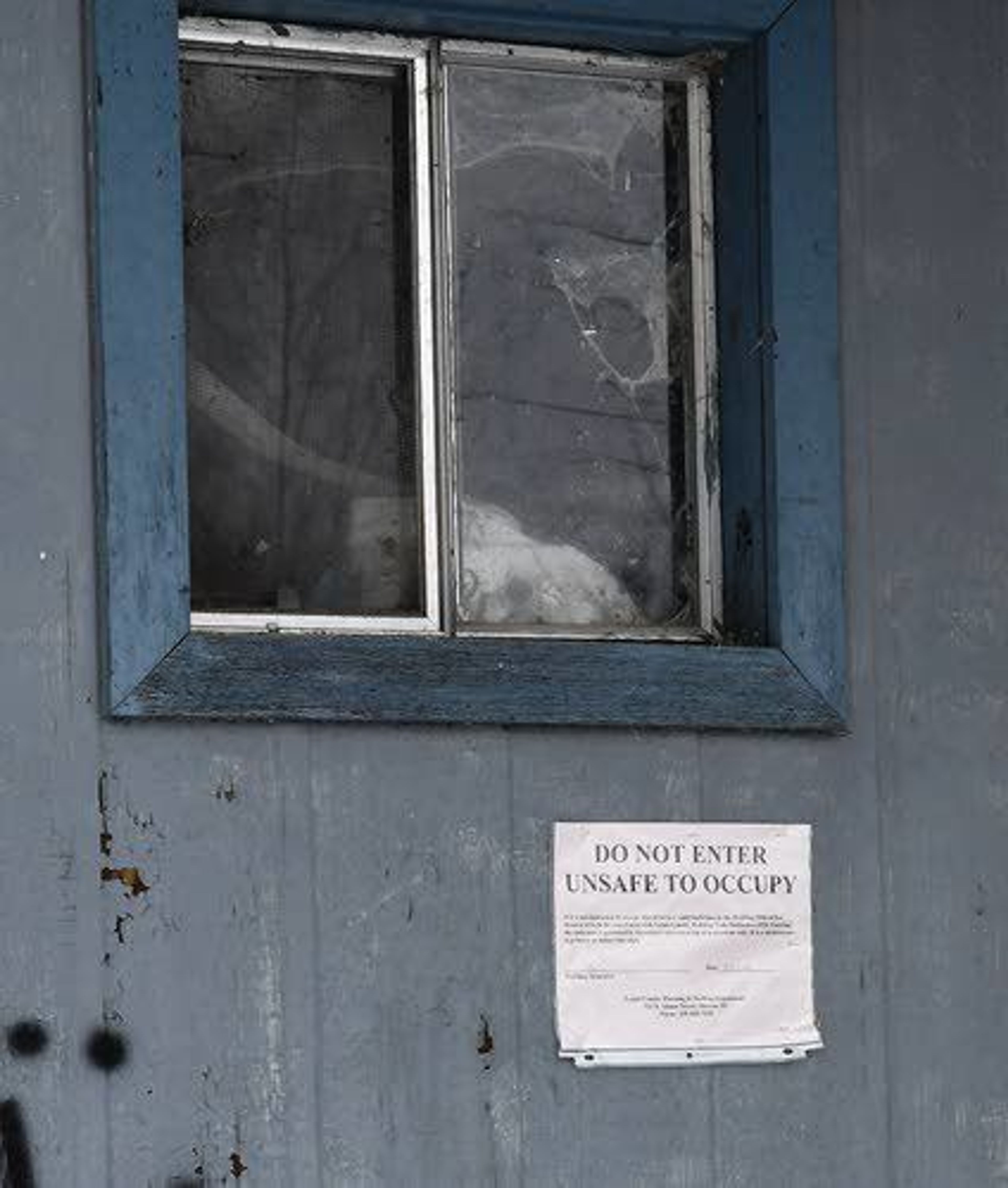 An abandoned structure at Syringa Mobile Home Park has an official notice warning people that the building is unsafe to occupy.