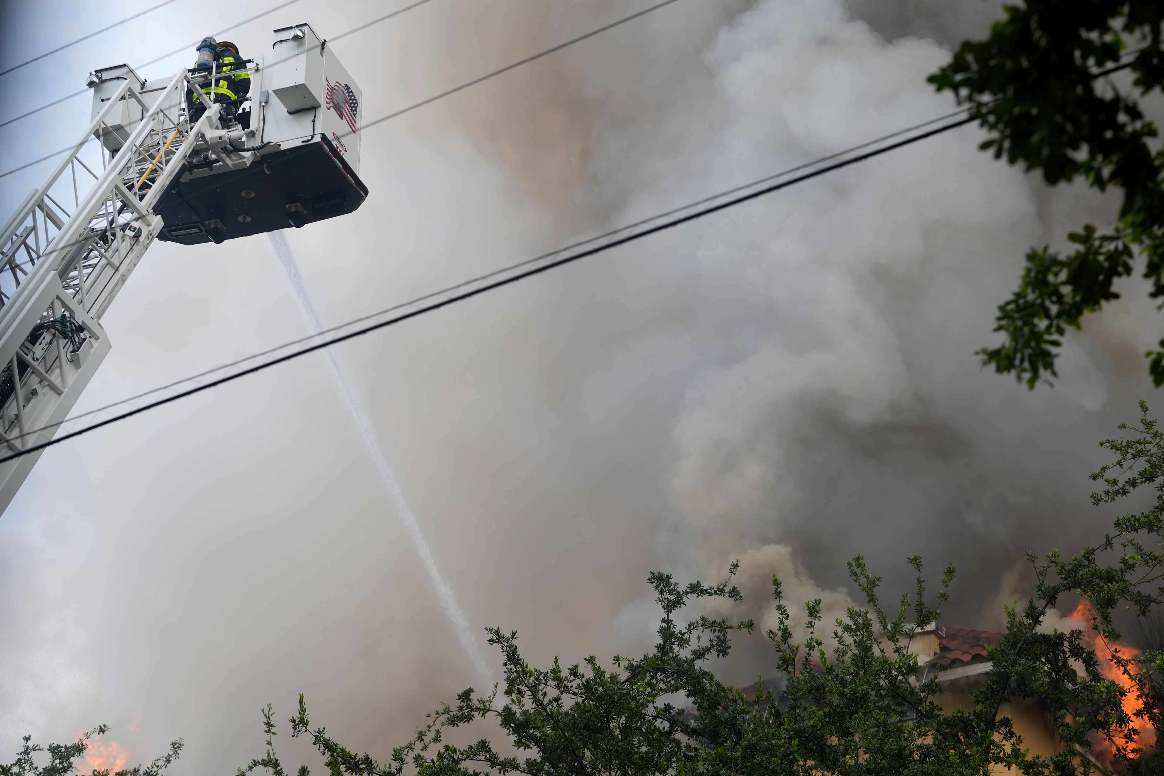 City of Miami Fire Rescue firefighters work at the scene of a fire at the Temple Court apartments Monday, June 10, 2024, in Miami.