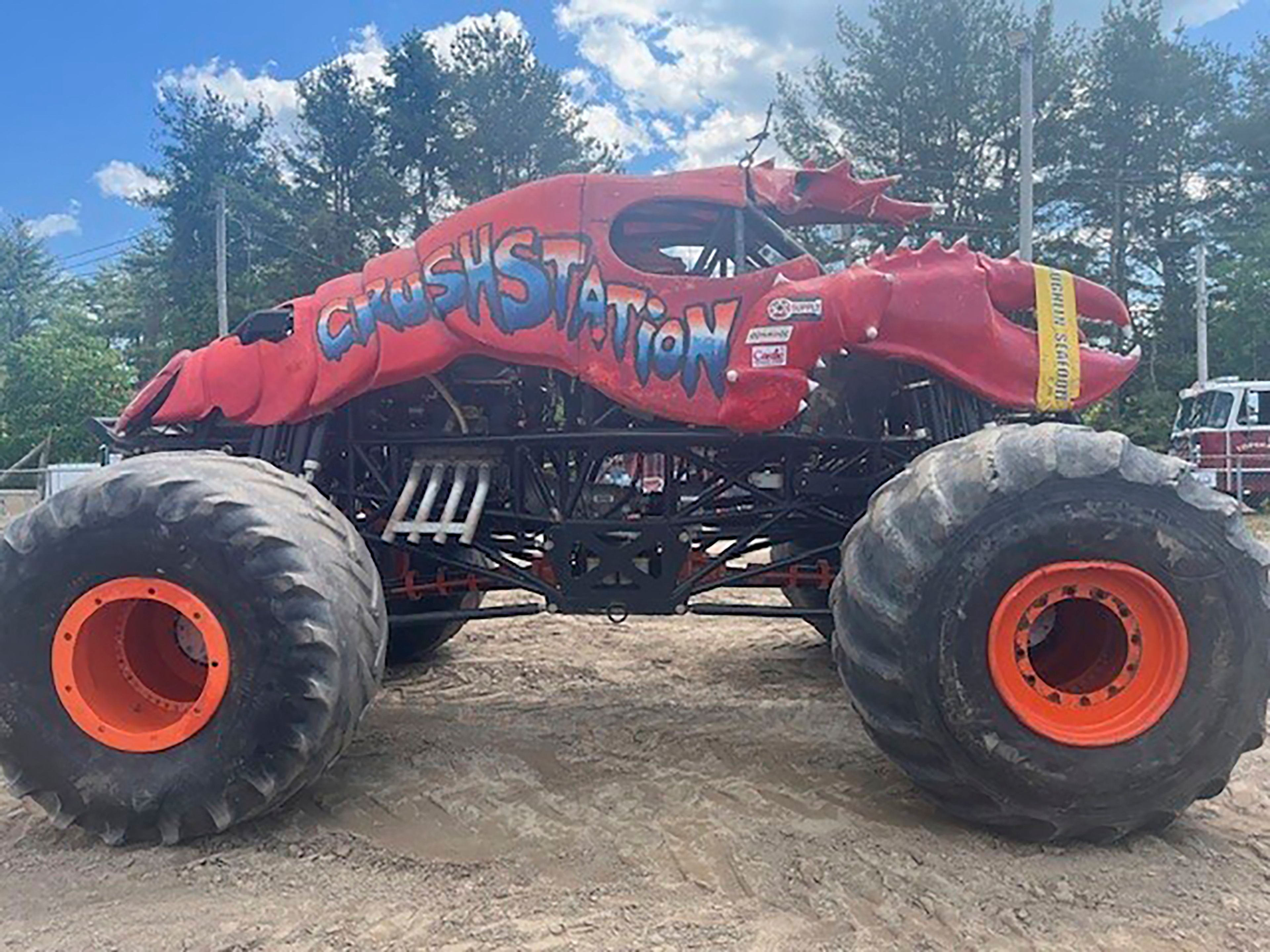 This photo provided by the Topsham Police Department shows a lobster-themed monster truck that clipped an aerial power line, toppling several utility poles while performing for a crowd at the Topsham Fairgrounds on Saturday, June 1, 2024.