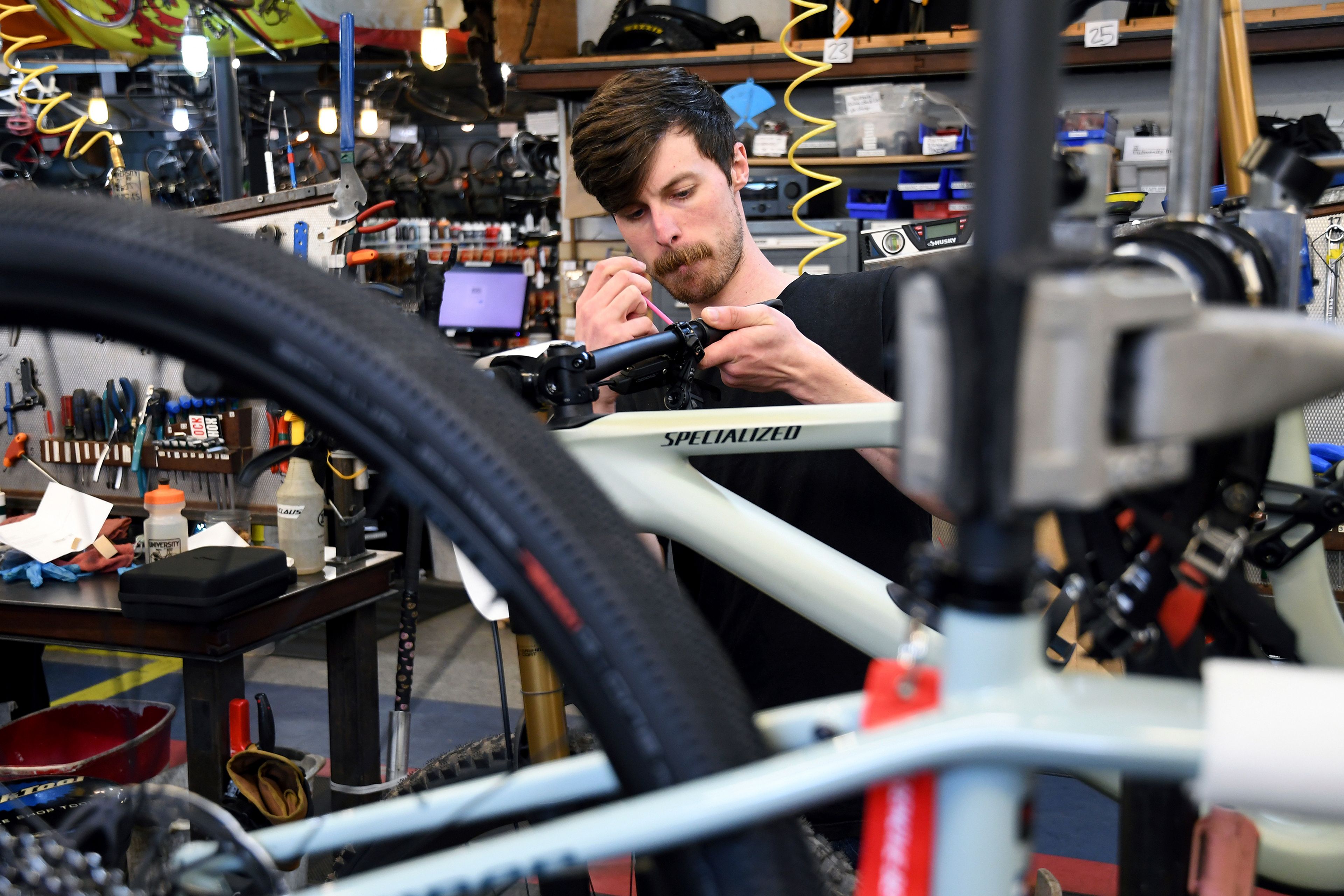 FILE - Mechanic Thomas Strater works at University Bicycles in Boulder, Colo., April 30, 2024. U.S. hiring decelerated sharply in July in the face of high interest rates as employers added a weak 114,000 jobs. (AP Photo/Thomas Peipert, File)