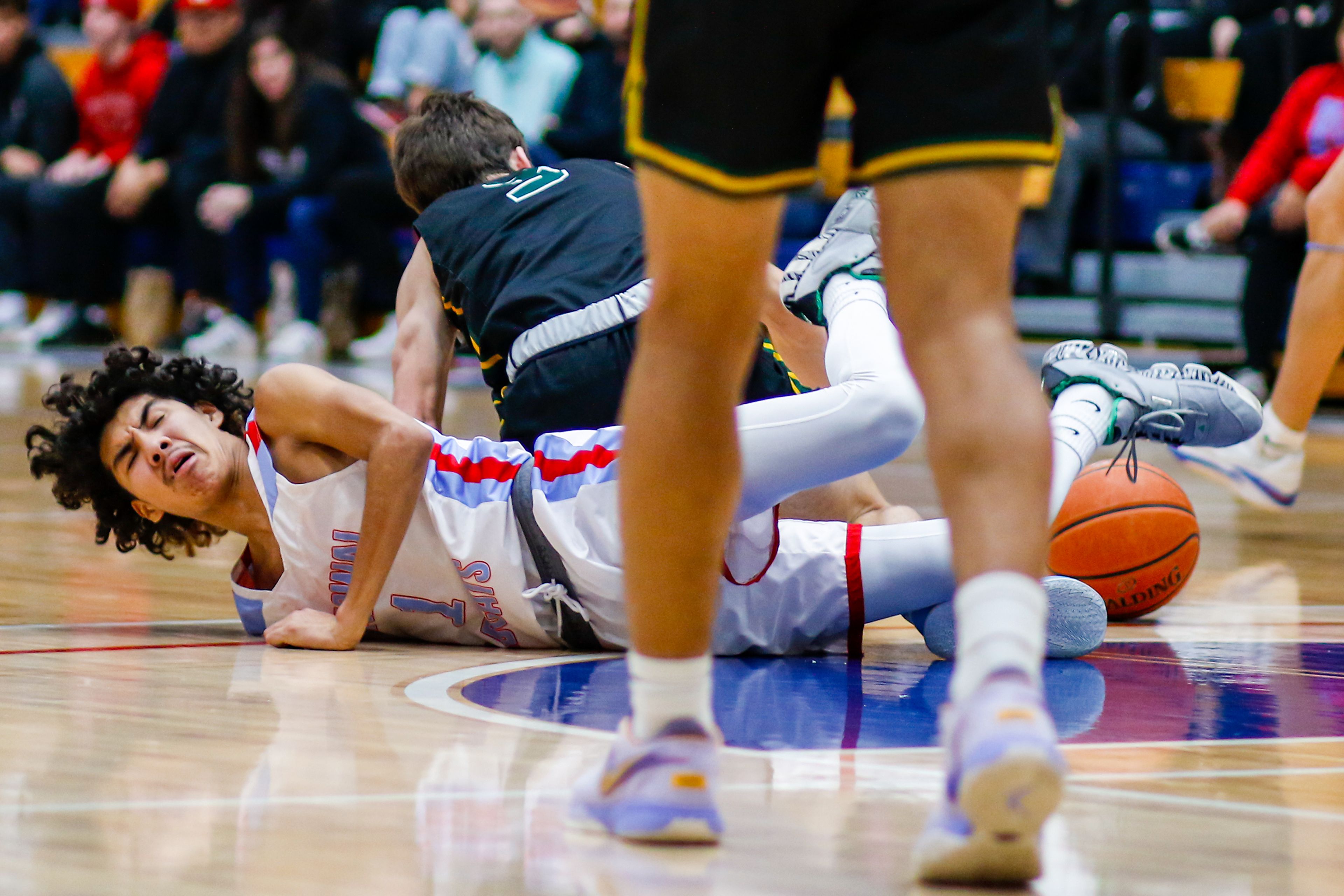 Lapwai guard Terrell Ellenwood-Jones and Shadle Park guard Jacob Boston fight for a loose ball Thursday during the Avista Holiday Tournament boys basketball final at the P1FCU Activity Center in Lewiston.