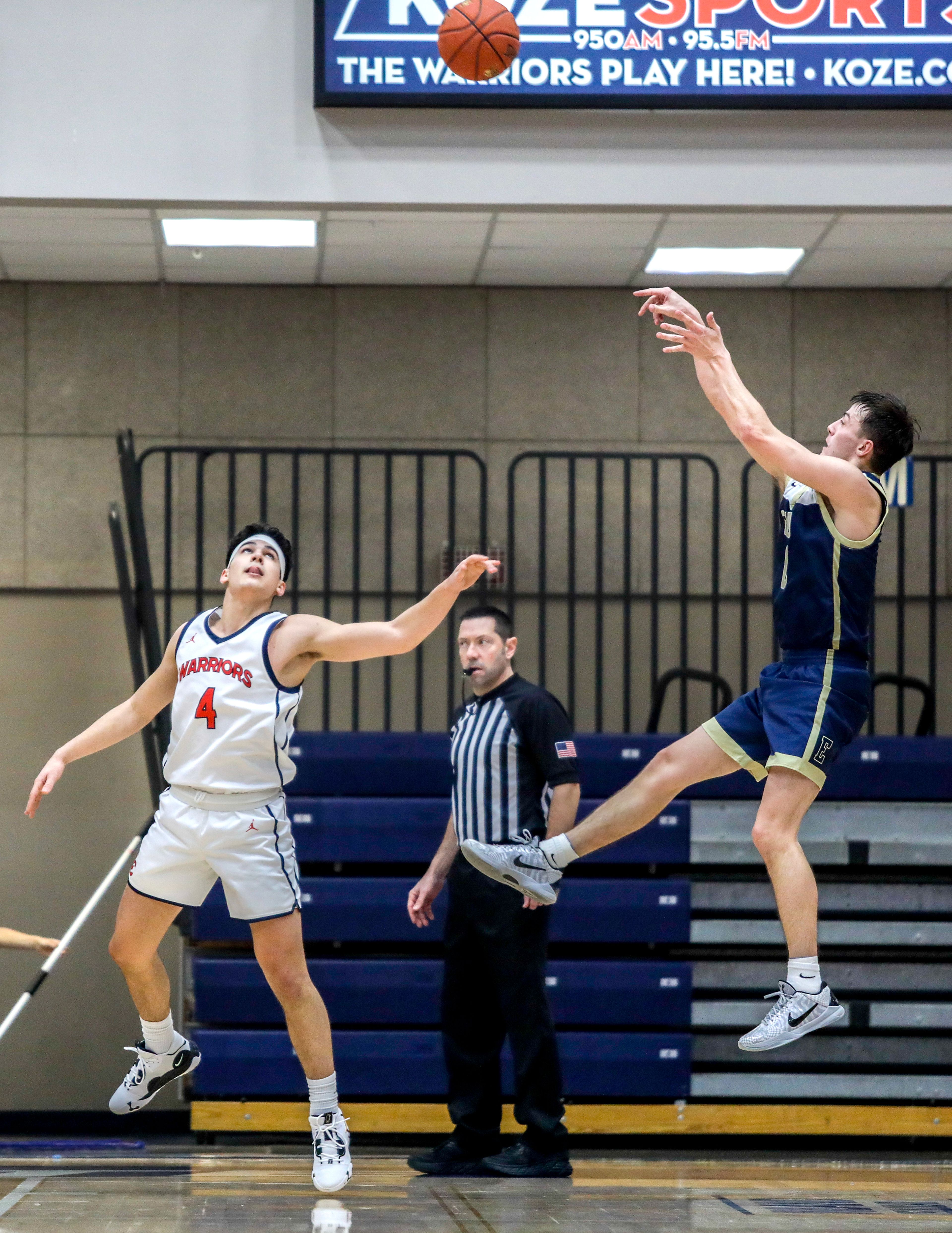 Eastern Oregon guard Phillip Malatare shoots as Lewis-Clark State guard Silas Bennion defends during a Cascade Conference game Friday at Lewis-Clark State College.