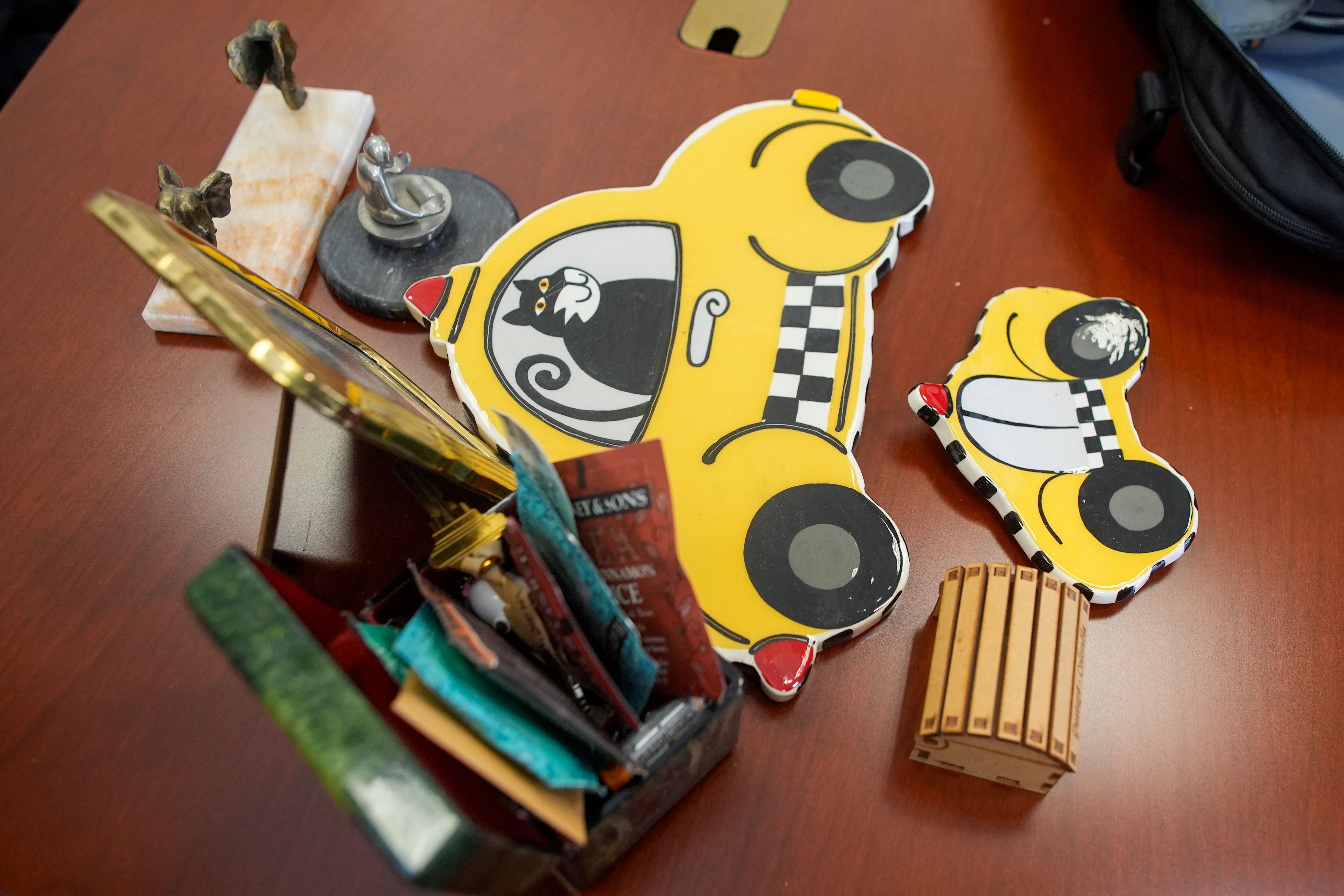 A cat riding in a checker cab is displayed Dr. Amy Attas' desk in her office at City Pets, Tuesday, April 23, 2024, in New York.